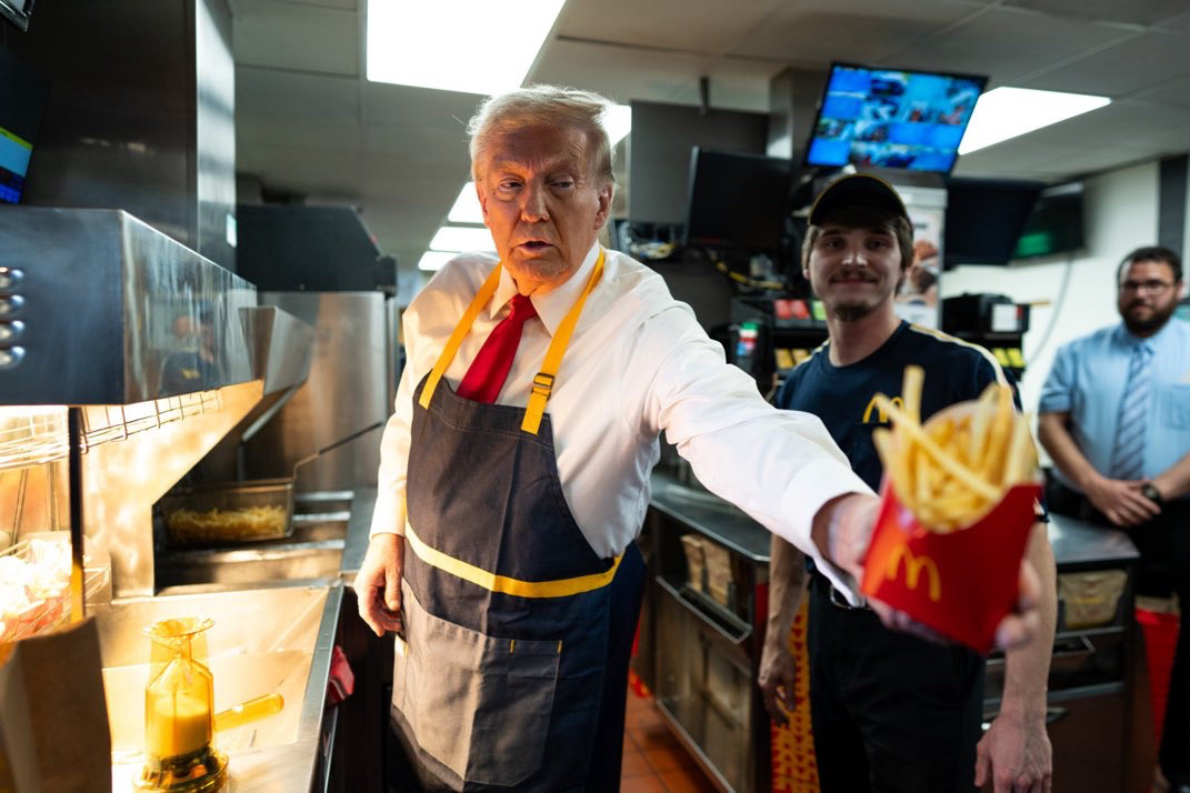 Donald Trump at his McDonald’s visit this evening. He is wearing the uniform and handing our fries