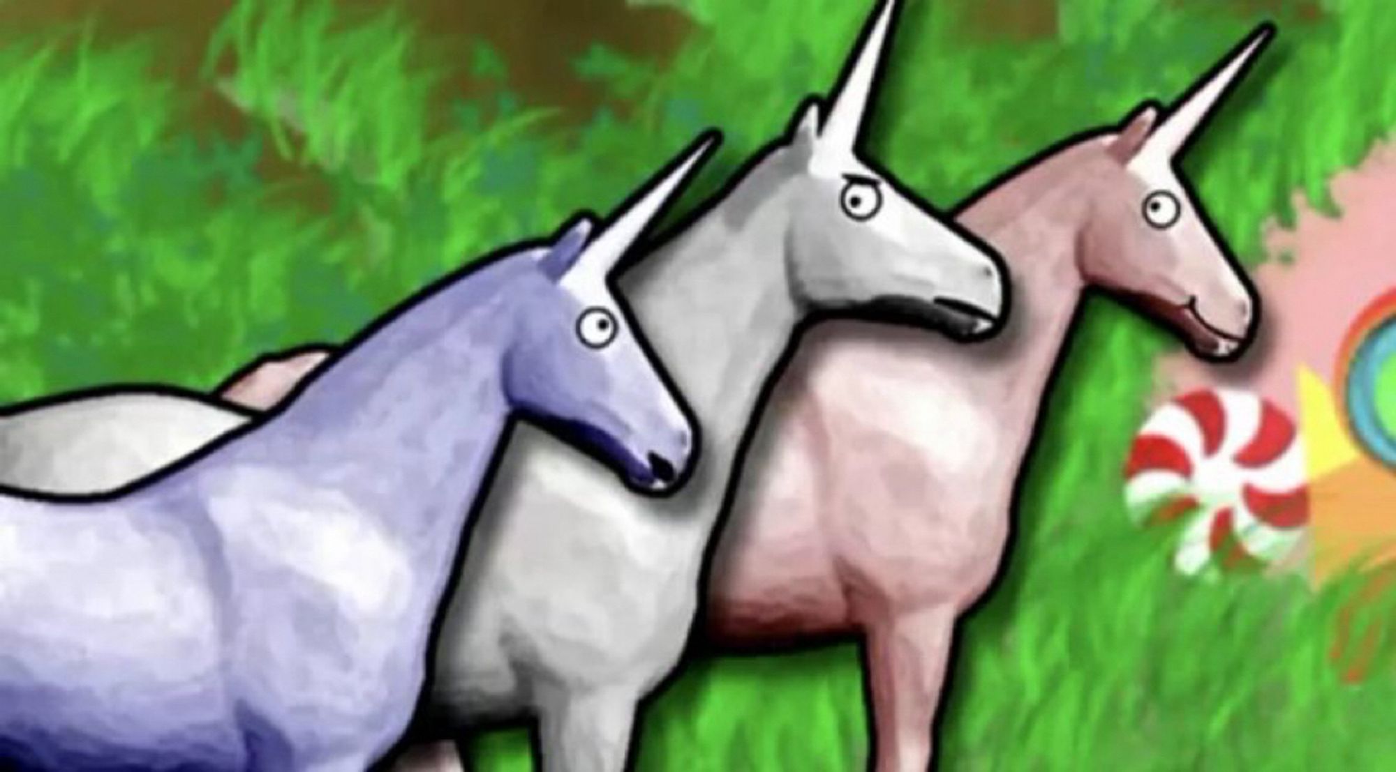 A screencap from the YouTube animation "Charlie the Unicorn." Charlie is a white unicorn standing in between a purple (left) and pink (right) unicorn. Charlie has an annoyed expression on his face and looks at the purple unicorn who's speaking to him. The pink and purple unicorns are both smiling. Behind them is green grass and a glimpse of a pink structure made of candy.