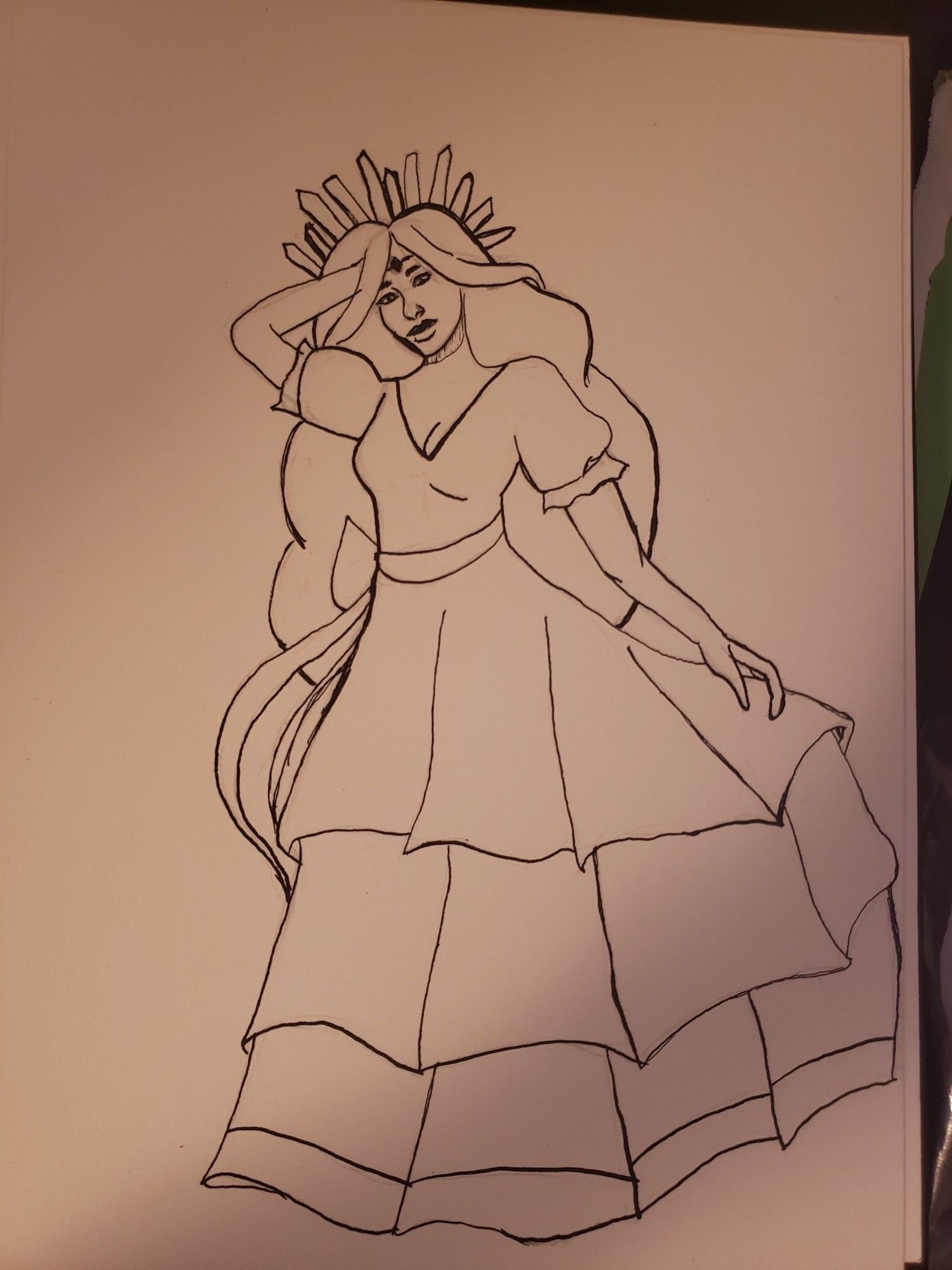 Drawing done in ink of a woman wearing a long tiered dress. She has a tiara made of crystals on her head, a ribbon on the middle of her dress, and a jewel on her forehead.