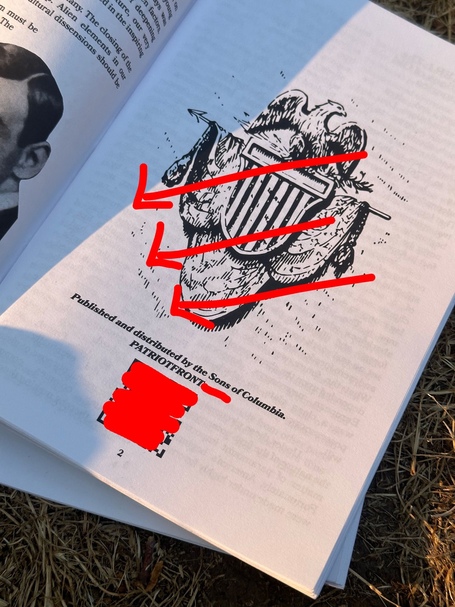 A page from the inside of the zine showing that it is a patriot front zine. It says; "published and distributed by the Sons of Columbia. PATRIOTFRONT" a url and QR code have been redacted, and the image on the page covered with three red arrows.