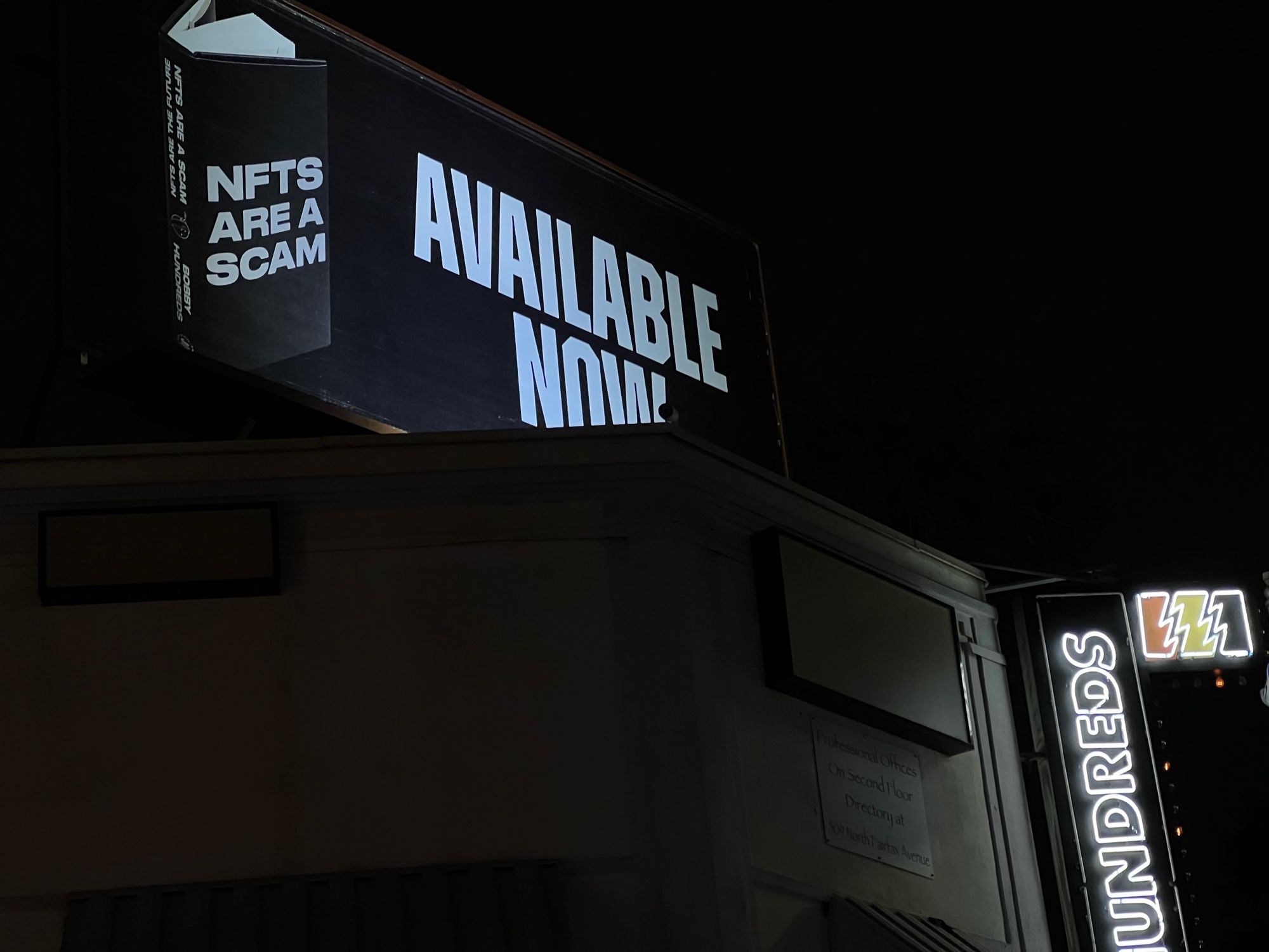 NFTs are a scam billboard on Fairfax above Hundreds & Supreme stores