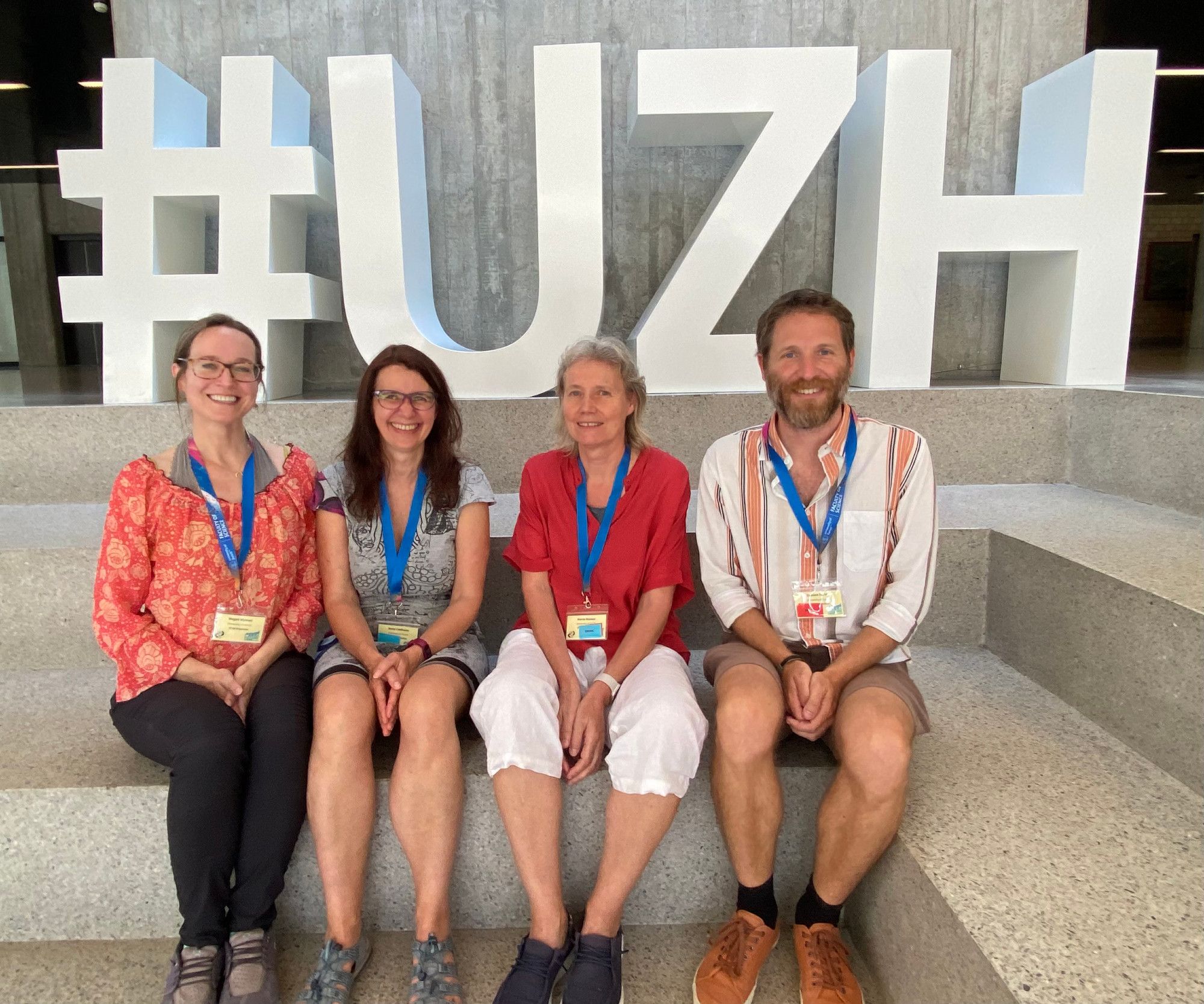 Organizers Anna Lindholm Megan Wyman Marta Manser and Damien Farine at the UZH sign