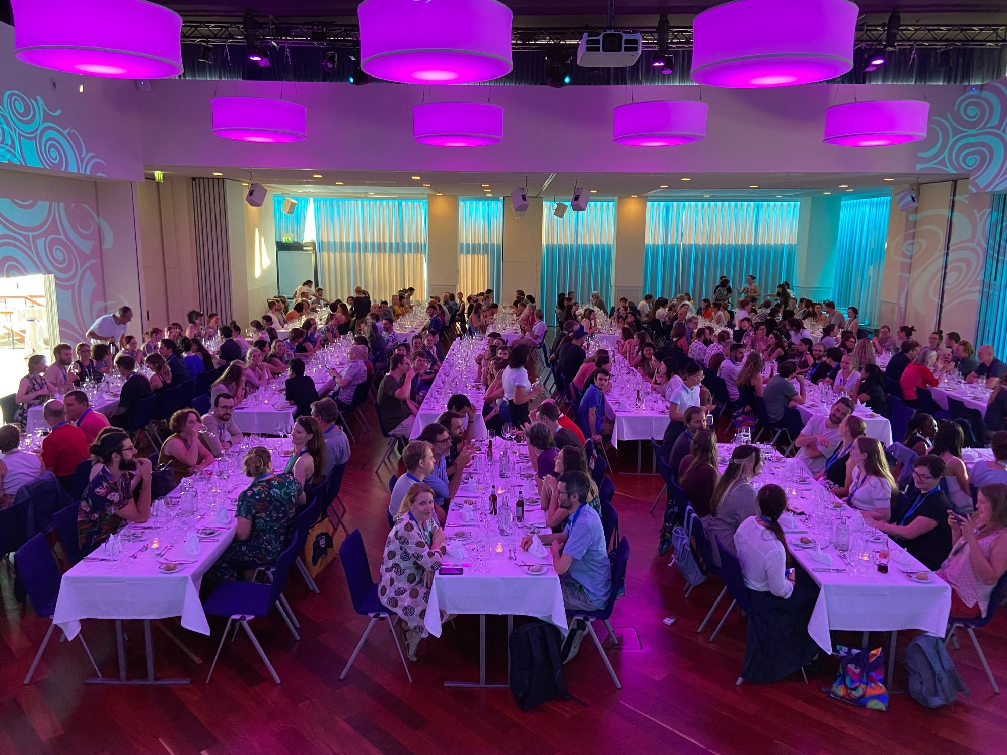 ASAB members sitting for dinner with purple glowing lights