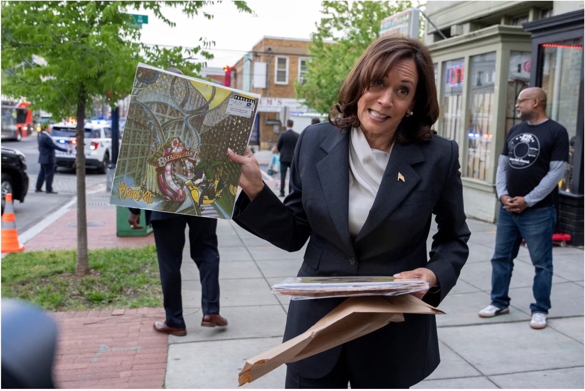 An edited image of Vice President Kamala Harris on a sidewalk in Washington, D.C., appearing to hold (but not in real life holding) the record 'Bizarre Ride II the Pharcyde.'