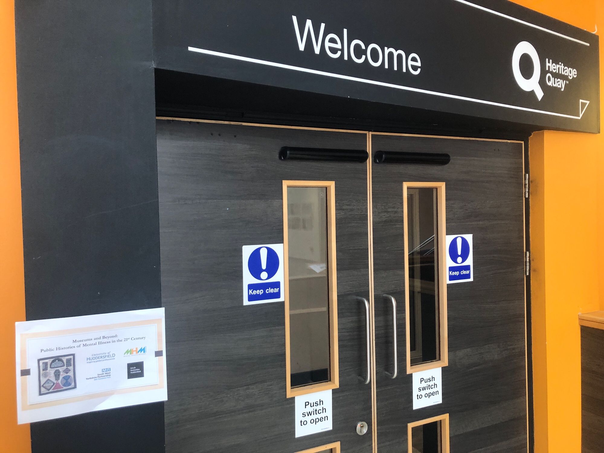 Entrance to Heritage Quay, the archive at the University of Huddersfield with a sign for the Museums and Beyond event.