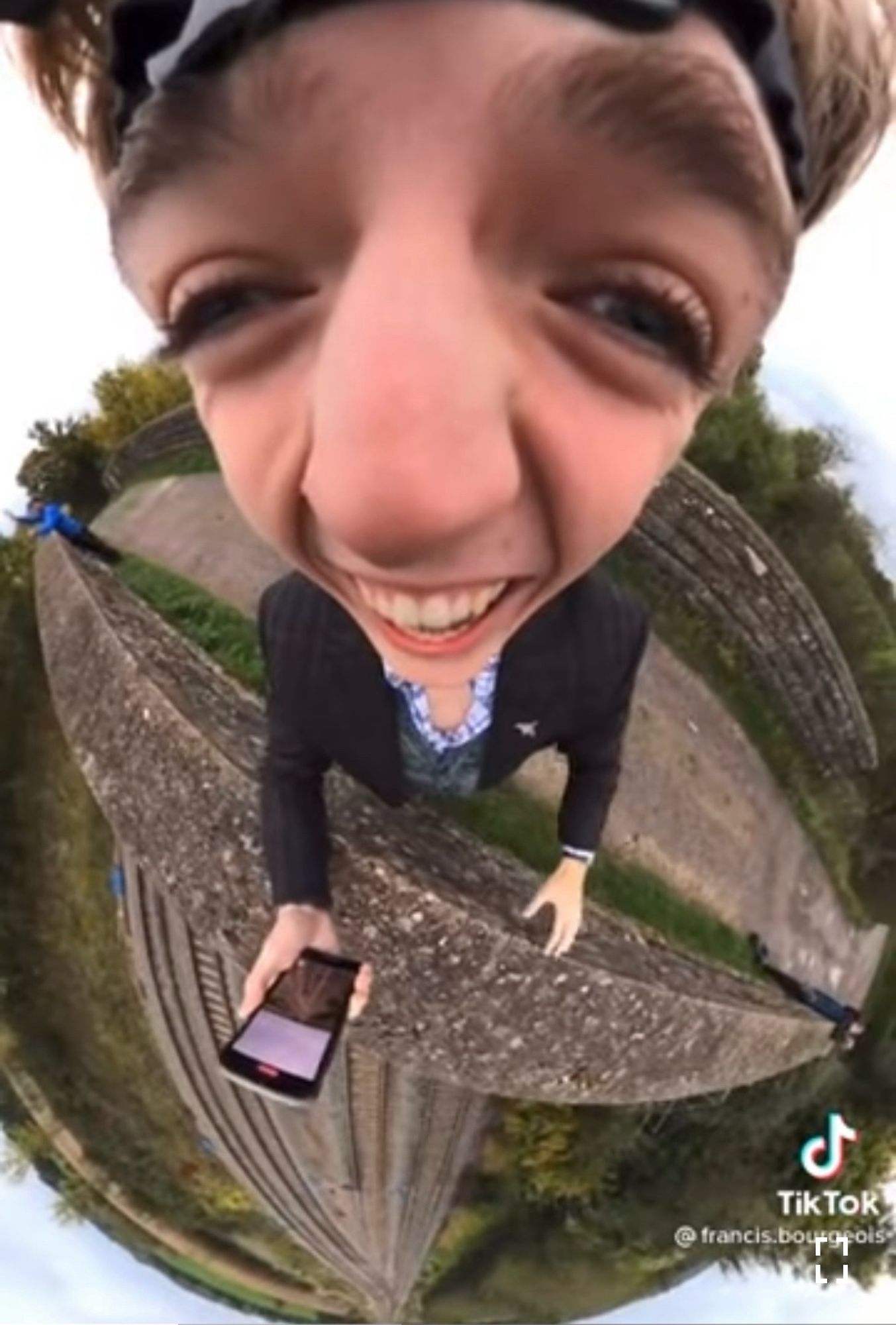 A fisheye lens mounted on a headband shows a very excited young English train spotter on a pedestrian overpass waiting for his friend Gordon the engineer to honk his horn as he passes underneath