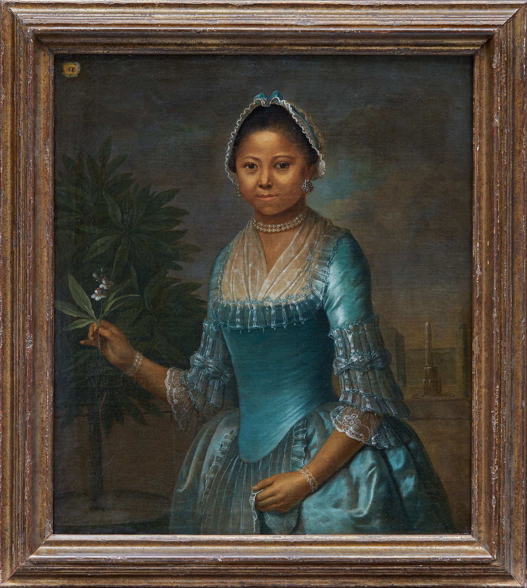 1770s, Unknown artist, possiblyy Jeremias Schulz, Portrait of a Young Lady Holding an Orange Blossom. If it is by Schulz then she was a resident of Amsterdam.

A young Black woman in a turquoise blue silk satin gown in the fashion of the 1770s, with transparent lace sleeve cuffs and fichu and a lace cap with matching blue ribbon. She wears a double strand pearl choker and matching bracelets, and jeweled earrings.