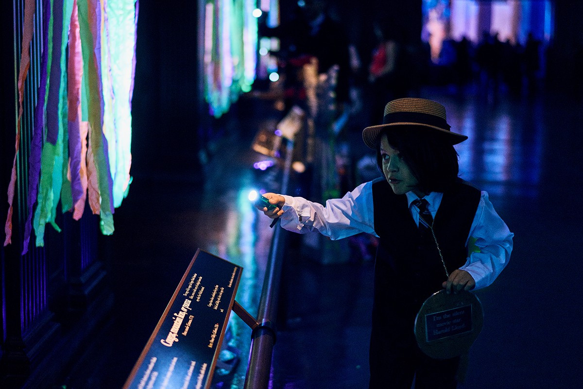 A young child takes part in a Halloween scavenger hunt during NHMLA's Haunted Museum event.