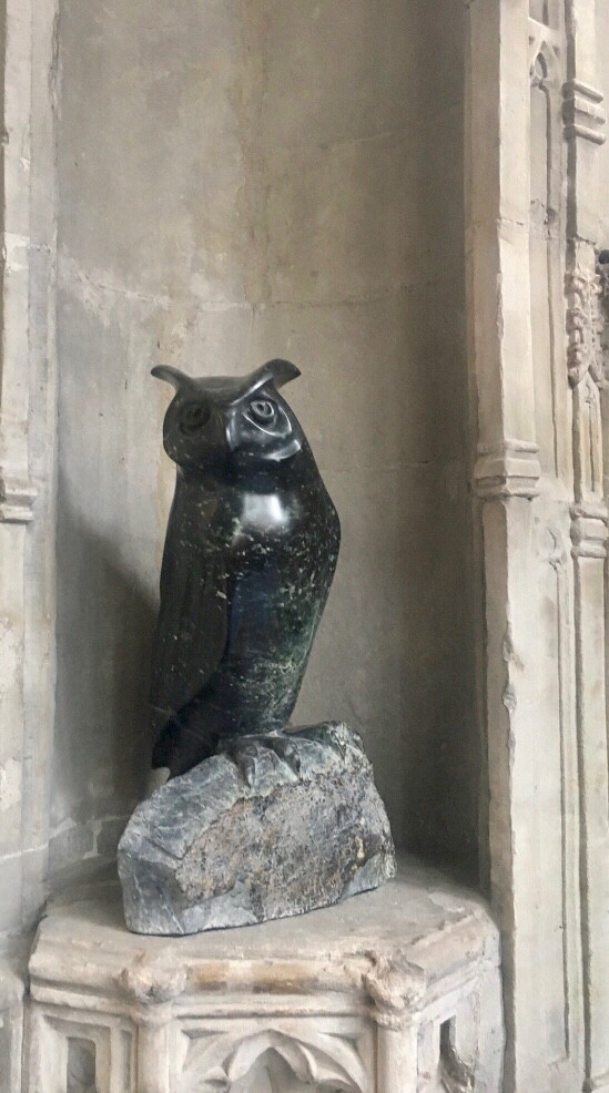 Image of an Eagle Owl sculptured from stone situated in a church.