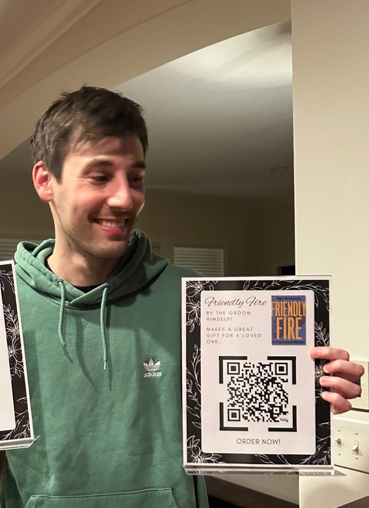 me in a green hoodie with a QR code flyer for friendly fire "written by the groom"