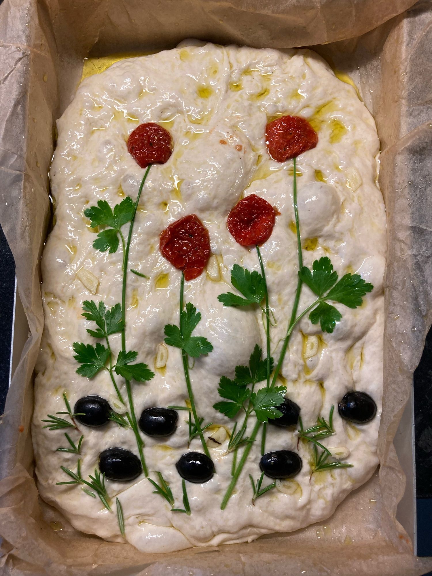 Using sundried tomatoes, coriander and olives, I created a poppy picture on my focaccia.