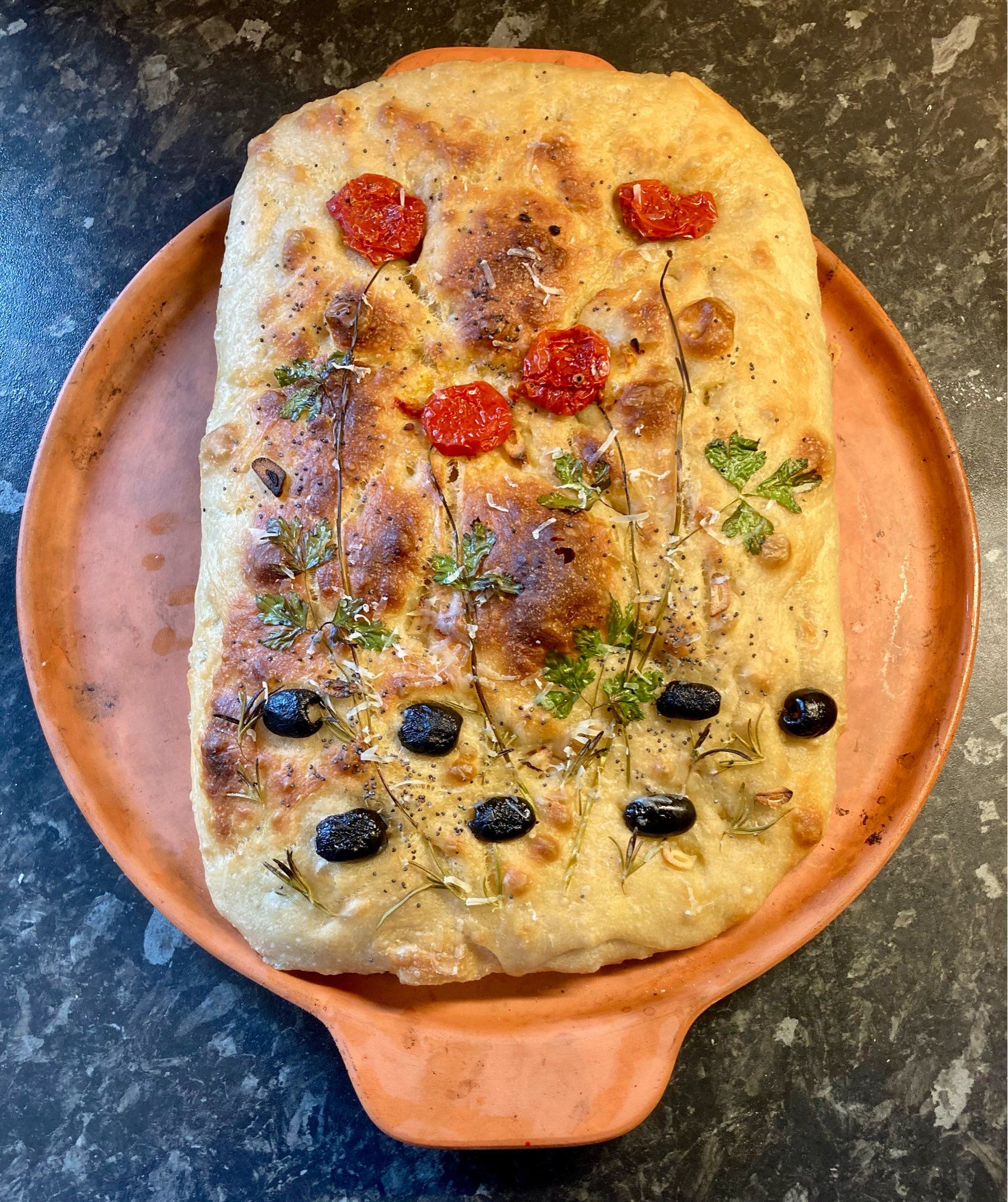 Baked focaccia with ‘poppy’ decoration, on my pizza stone.