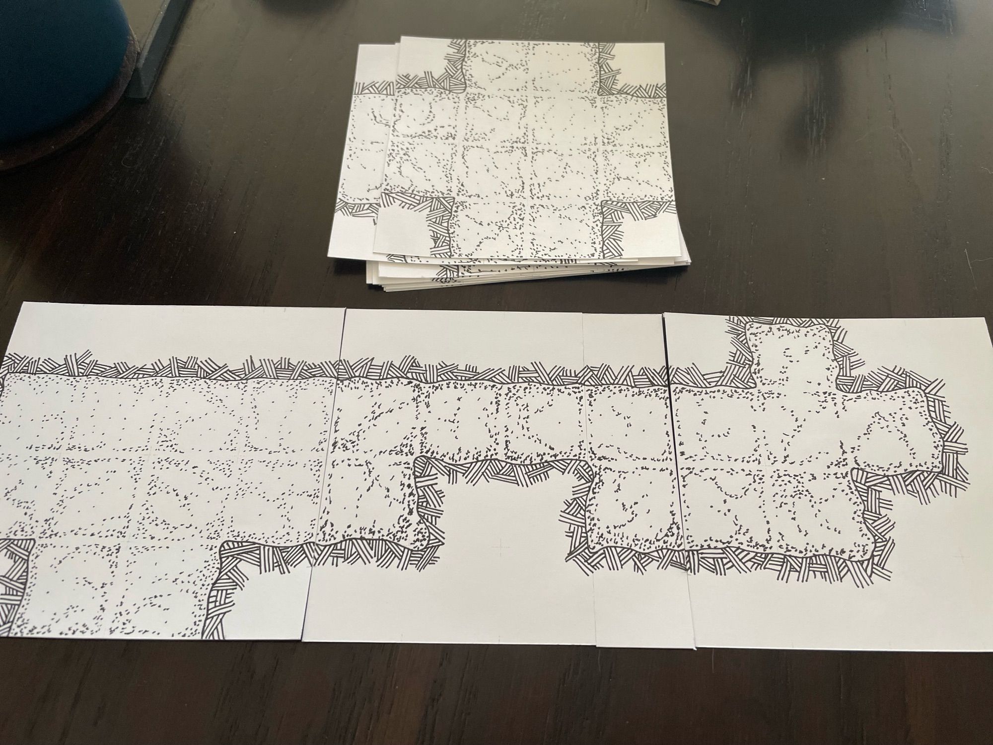 Three pen and ink stippled 4” squares, each with a modular dungeon tile drawn on.