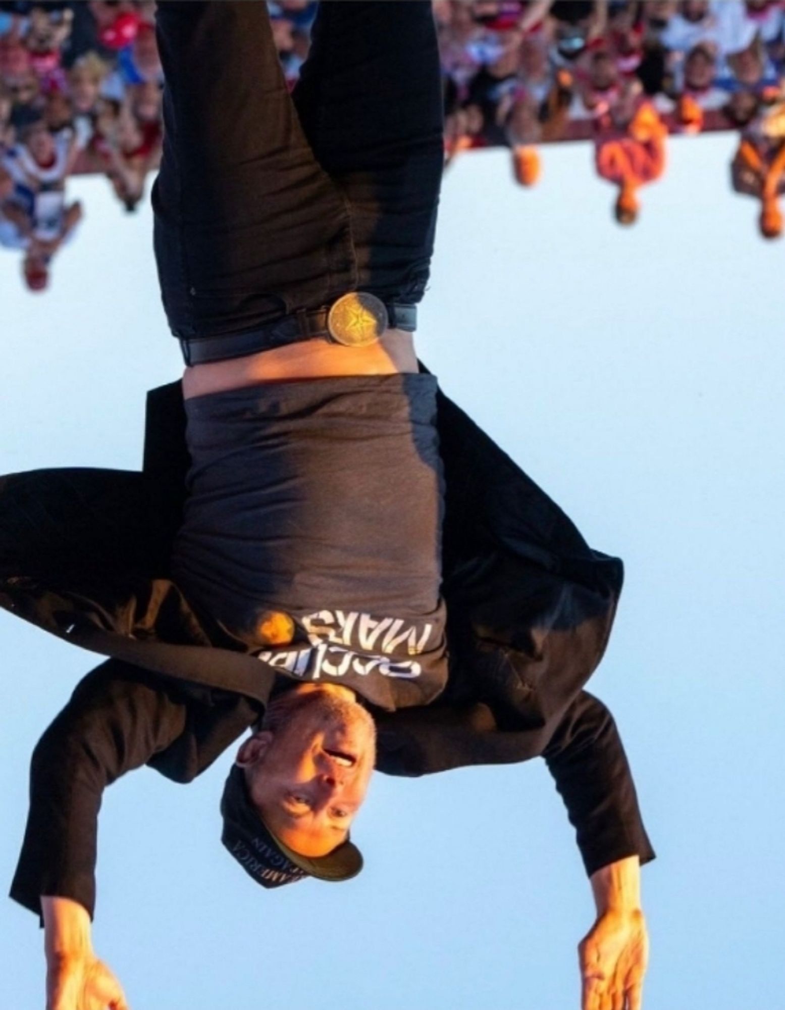 Elon Musk jumping at the Trump Rally, presented upside down