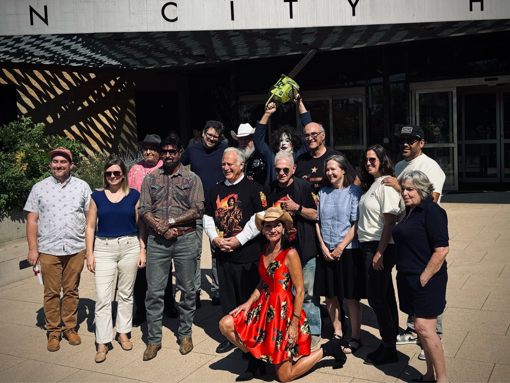 Leatherface, actors from Texas Chain Saw Massacre, and the Mayor of Austin, outside City Hall