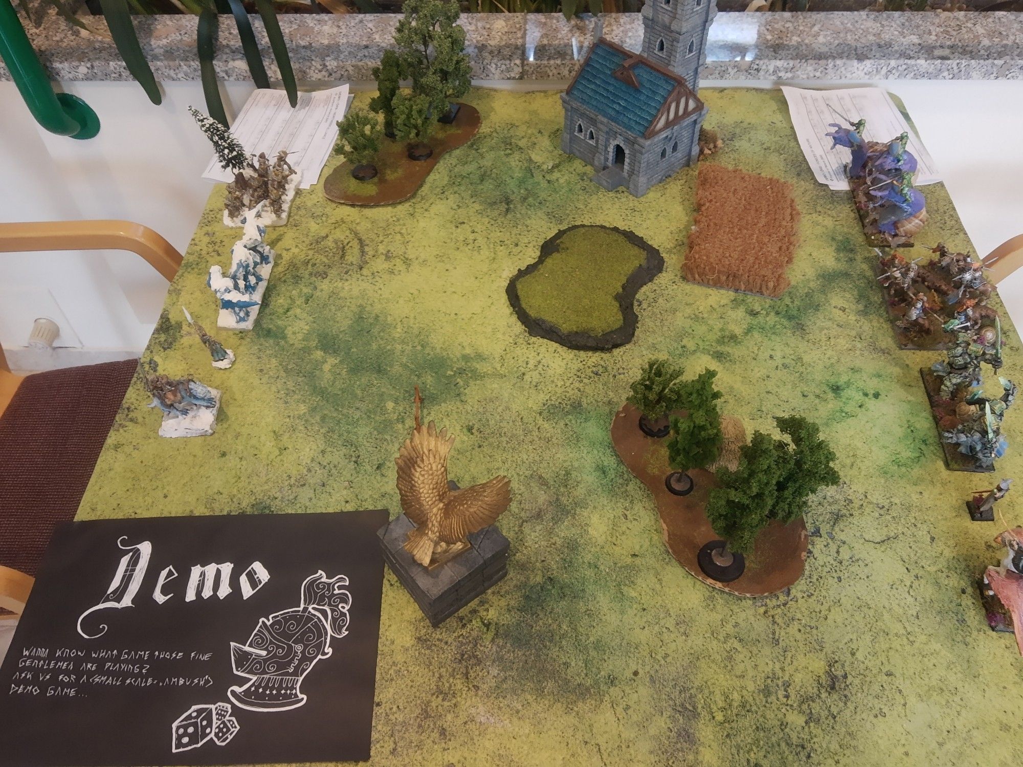 A demo table with 2 600 points Kings of War armies for visitors to try the game