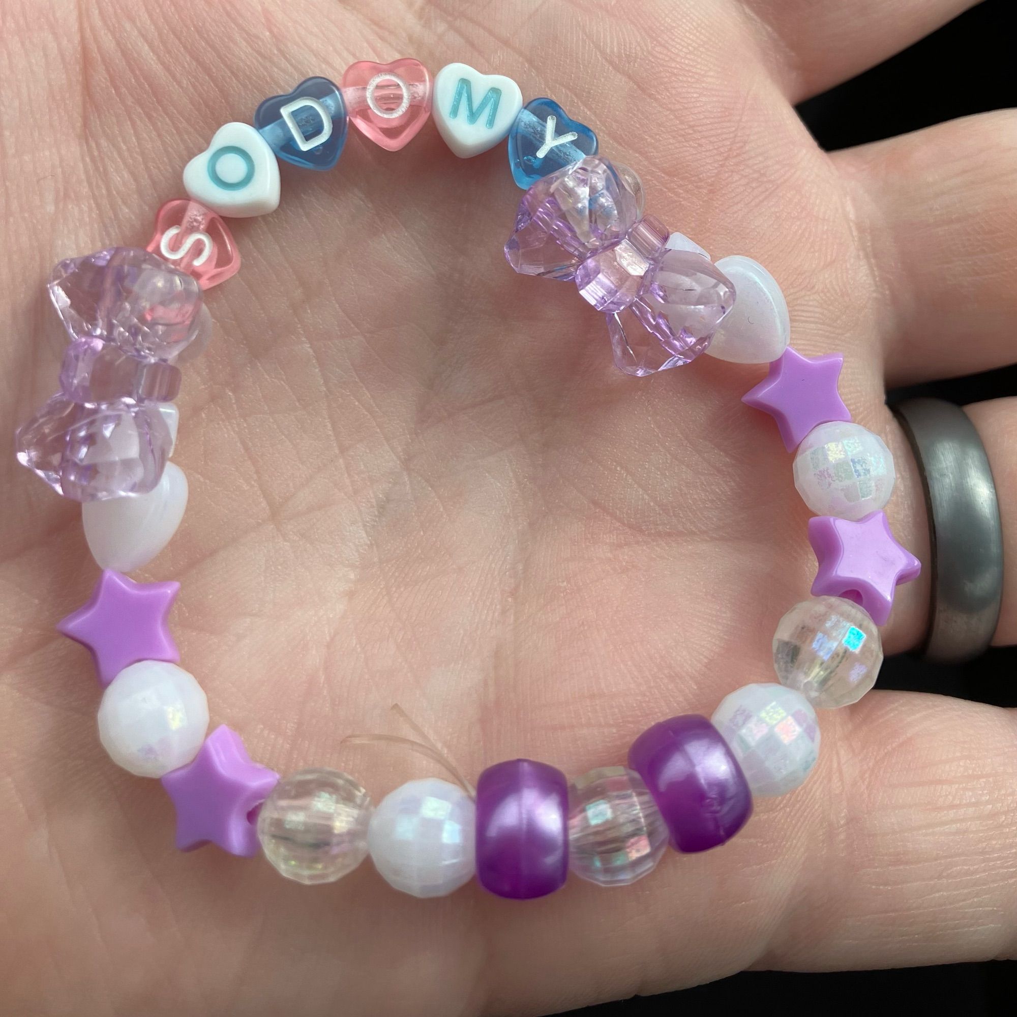 Rave bracelet that says “sodomy”