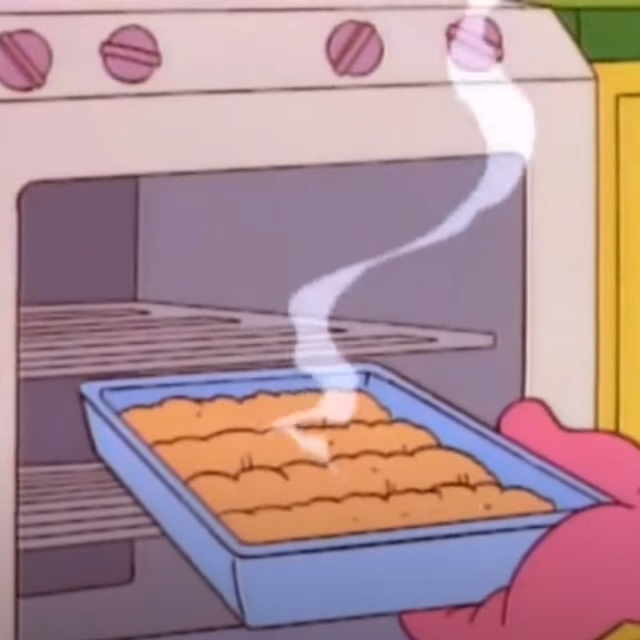 A picture of a lasagna fresh out of the over from the cartoon Garfield and Friends but the lasagna looks more like puff pastry or lumpy mash potatoes