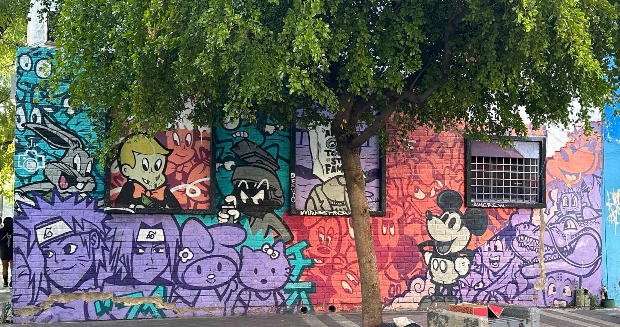 Colorful Graffiti in Guadalajara, Mexico featuring tons of animated characters like Mickey Mouse, Bugs Bunny, etc.