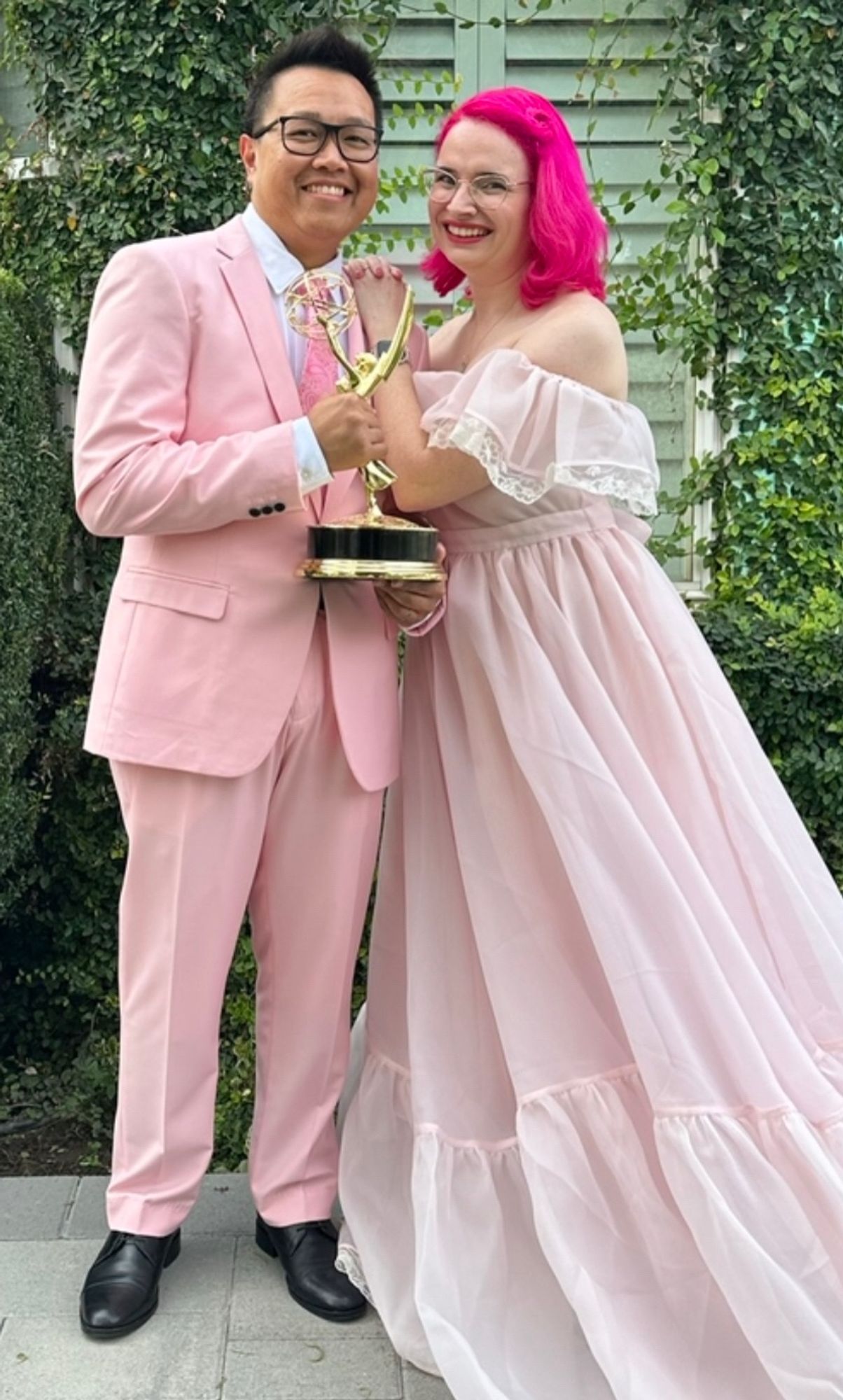 Ben and Jessie in matching pink outfits with an Emmy