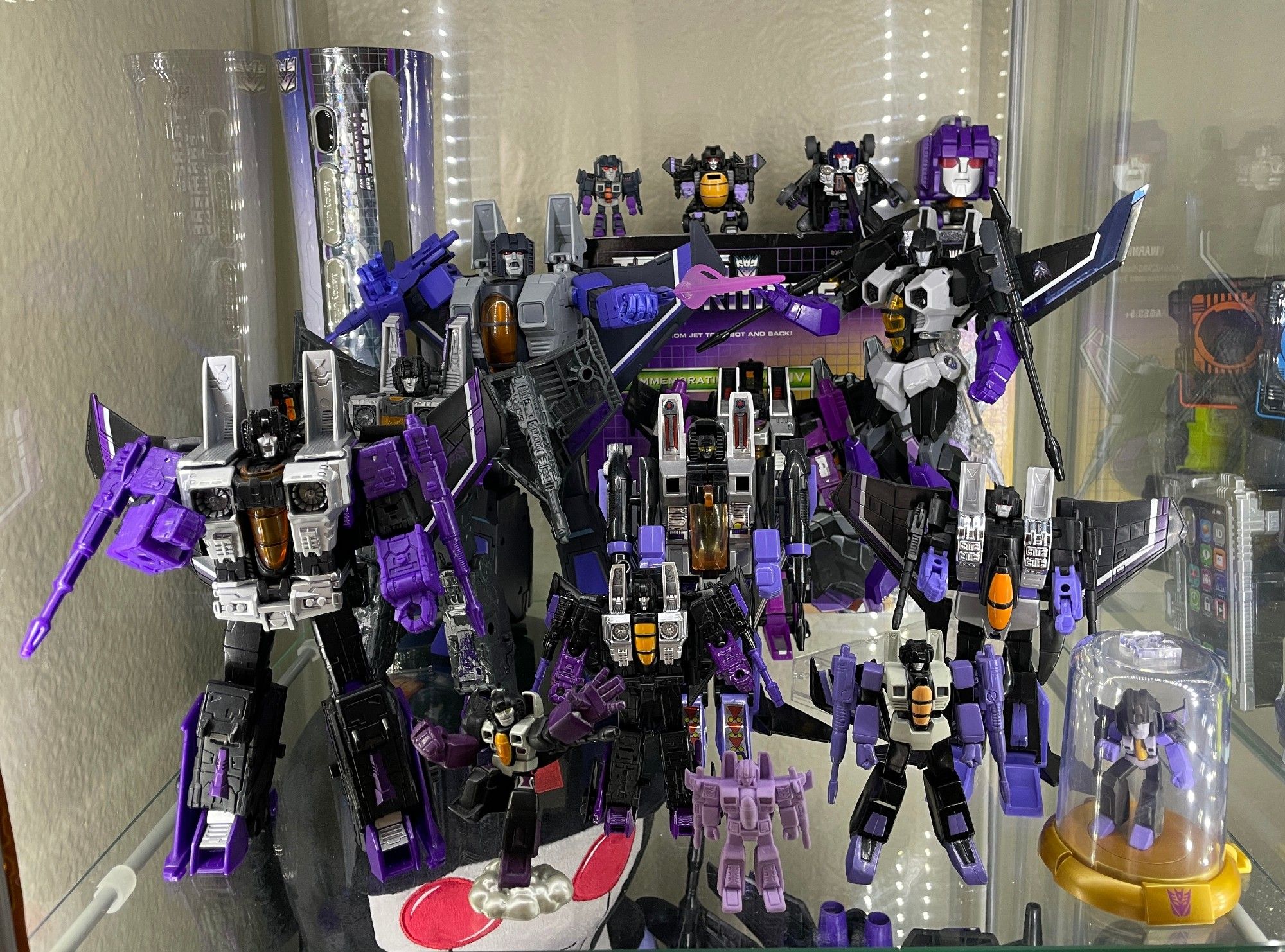 A display shelf filled with Skywarp toys. Mostly versions based on his original G1 design.