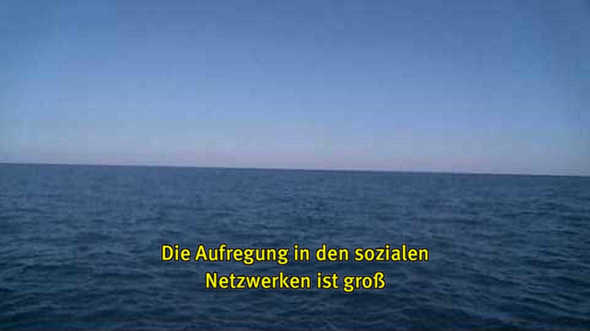 Webcam-Foto vom Meer, untertitelt mit gelber Schrift: "Die Aufregung in den sozialen Netzwerken ist groß"