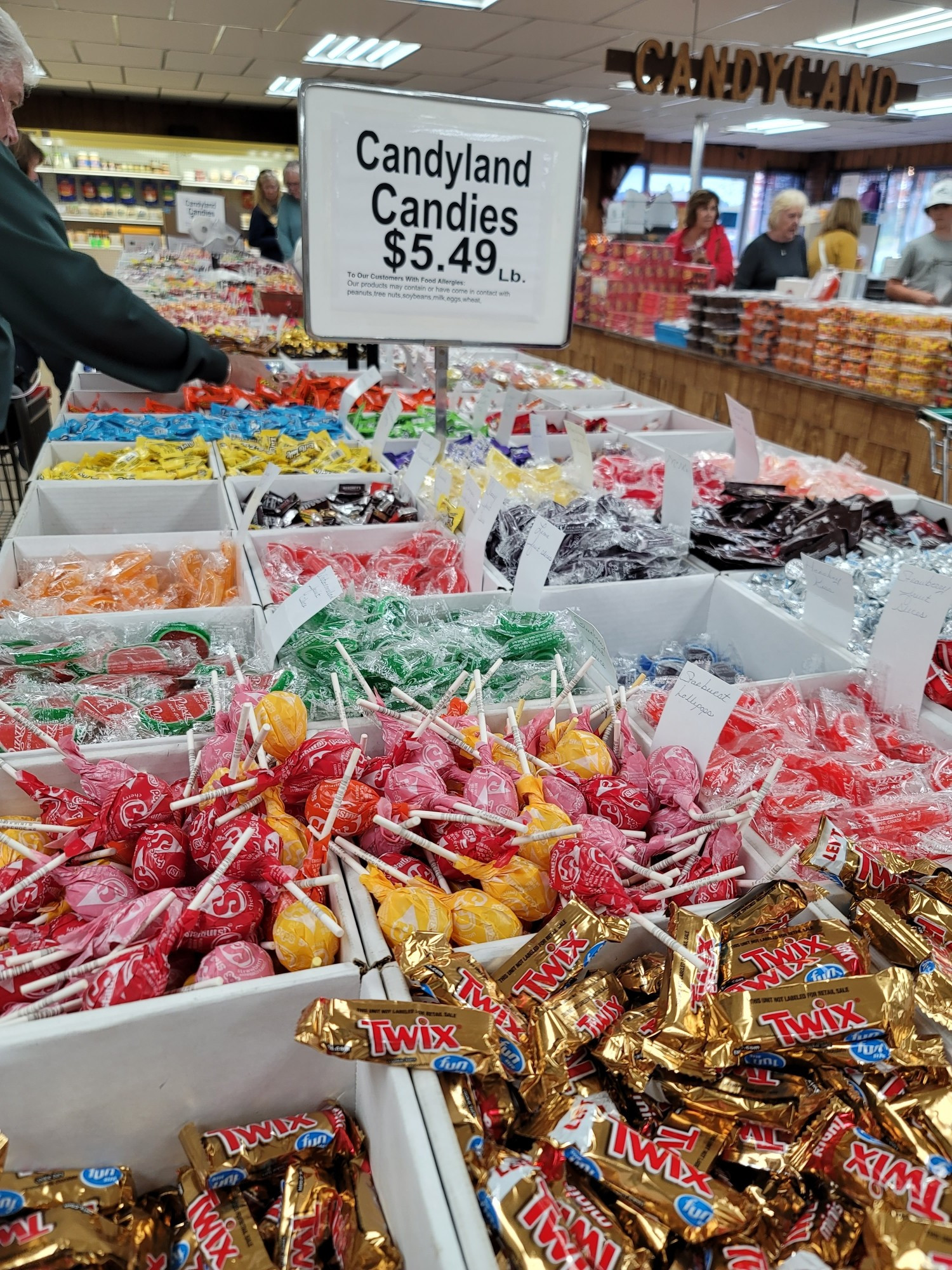 Multiple colored candy in a boxes on a table.