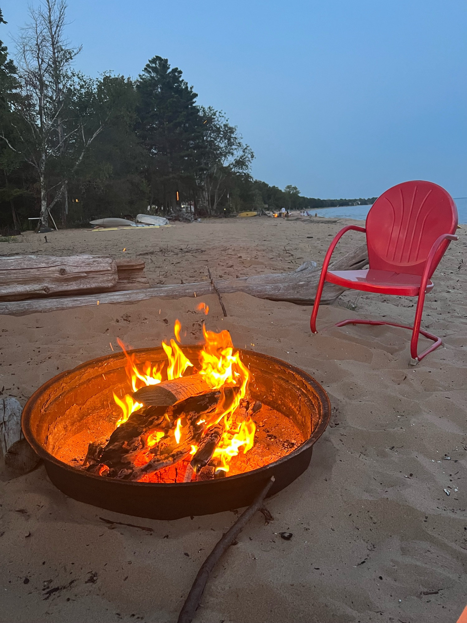 Campfire on a sandy beach at dusk