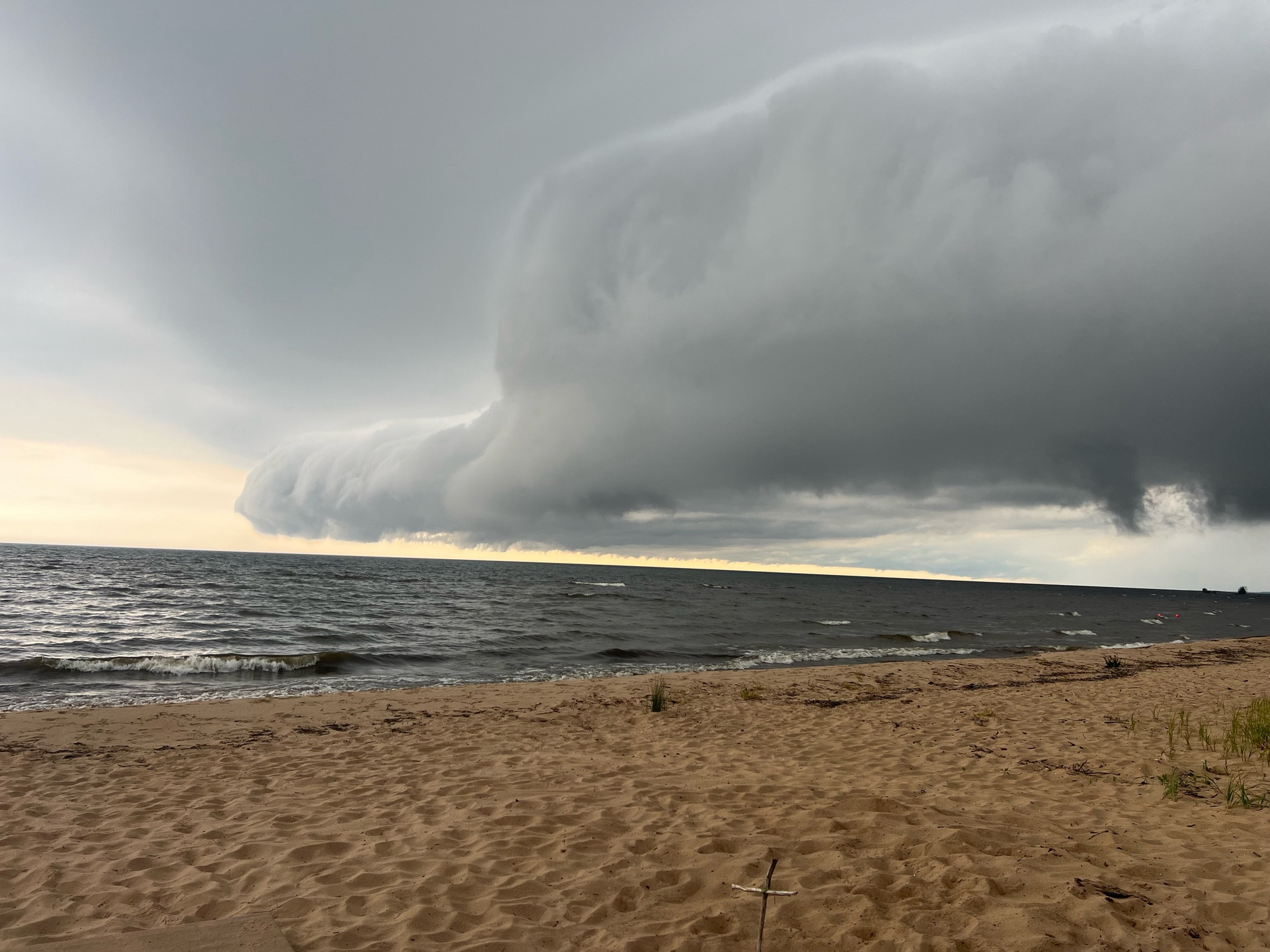 Dense clouds over a Lake Michigan sandy beach before a storm