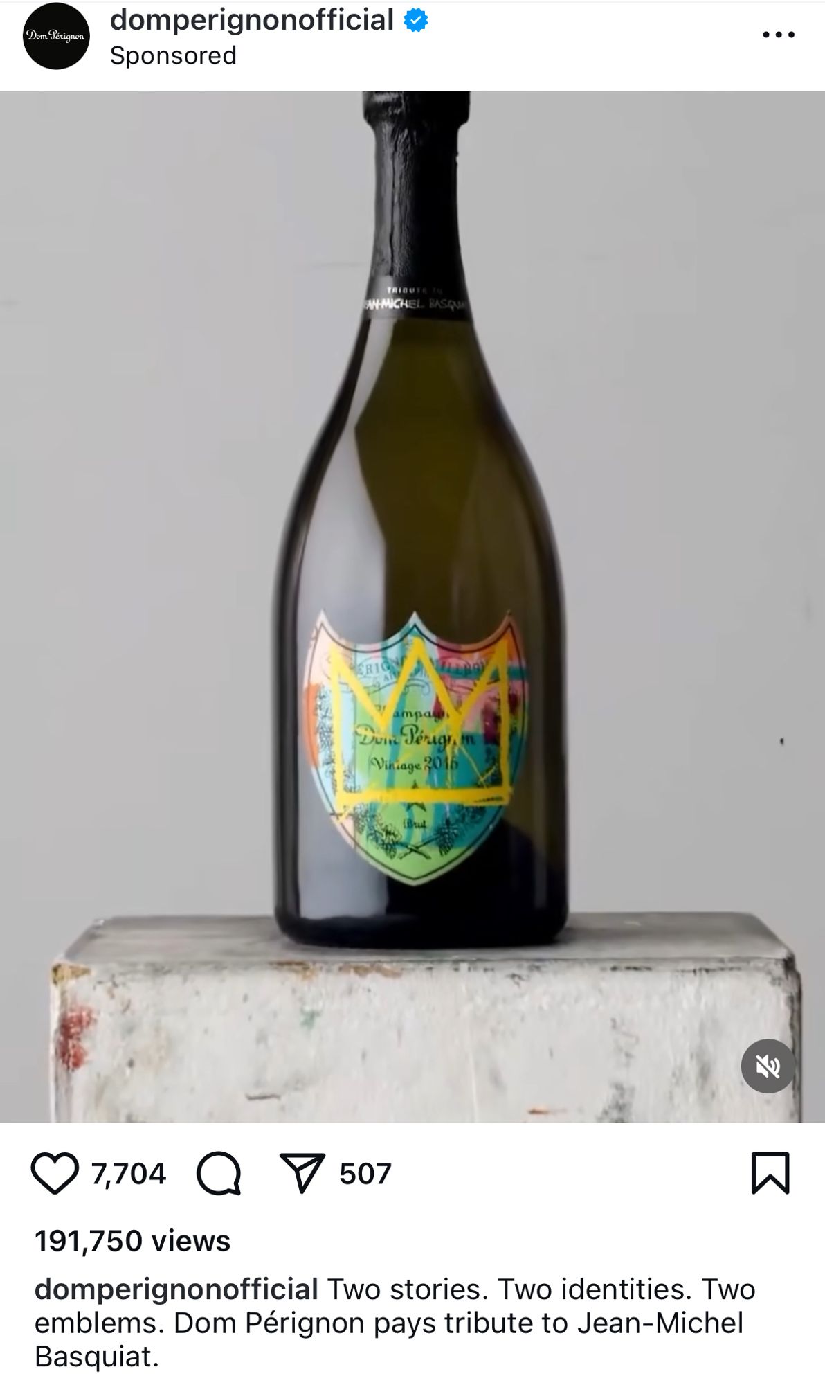 A bottle of Dom Perignon champagne on a white block with a design from Jean Michel Basquiat (a yellow crown) overlayed on the label.