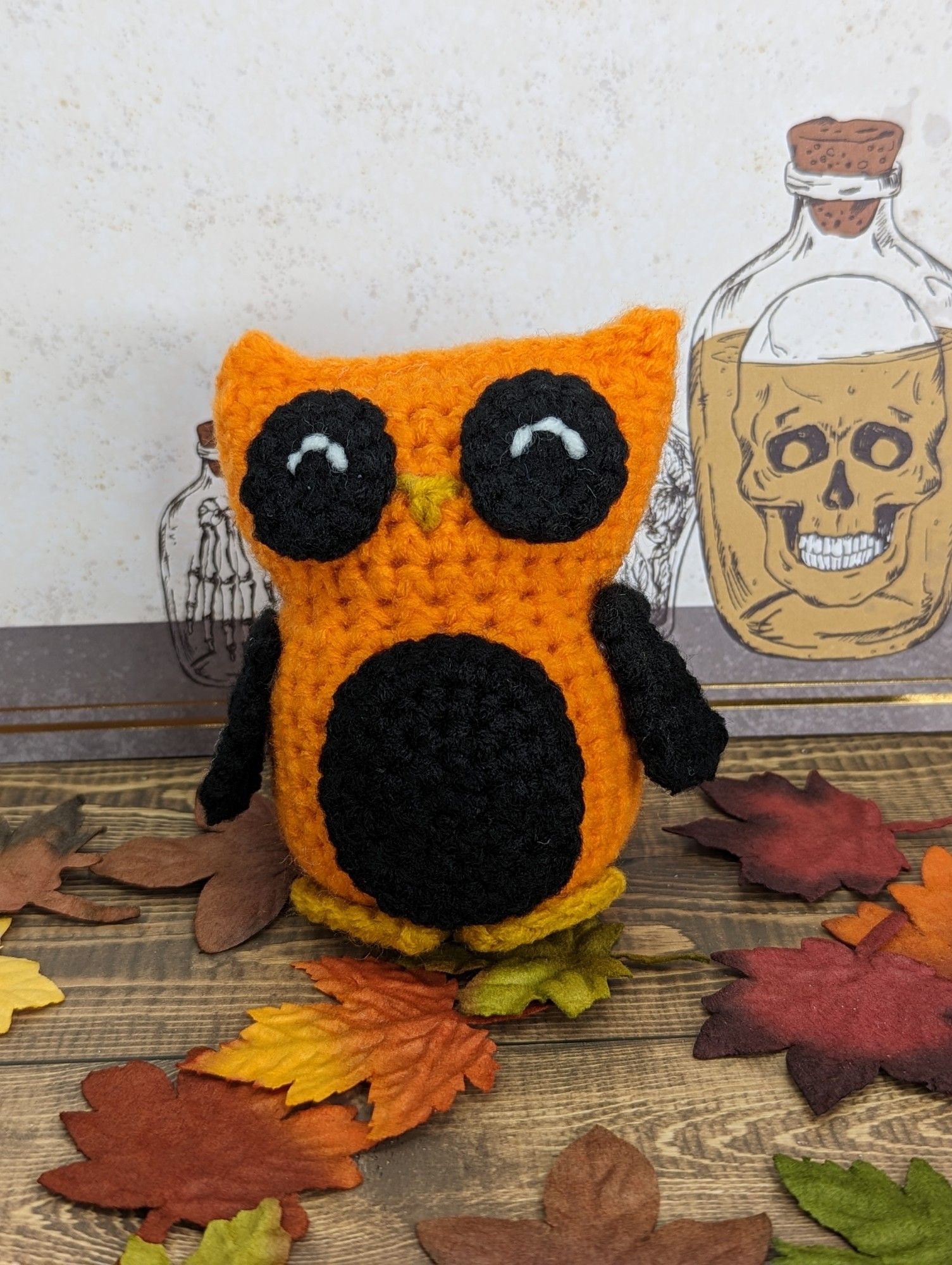 An orange and black crocheted owl