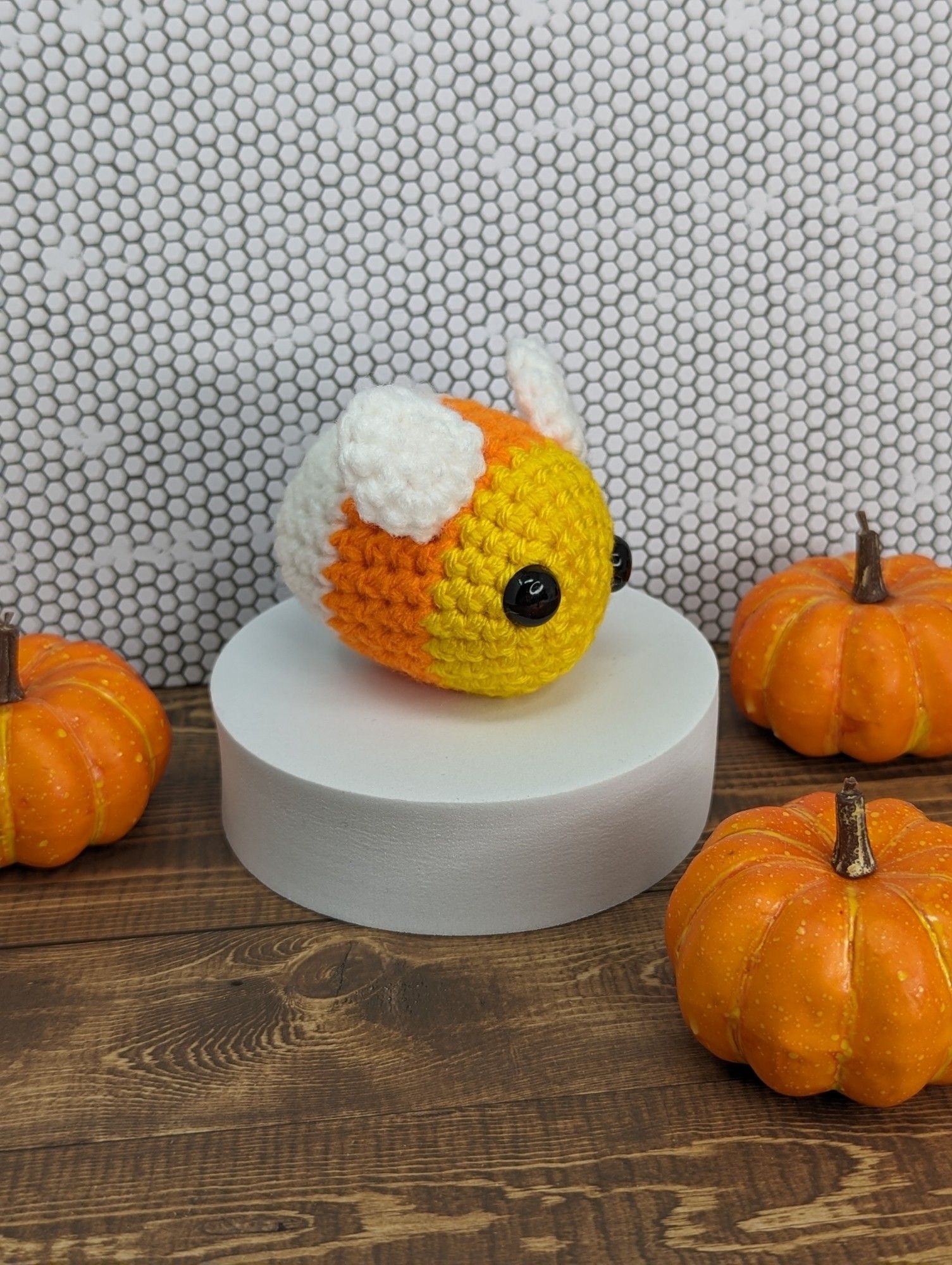 A crocheted candy corn dressed up like a bee