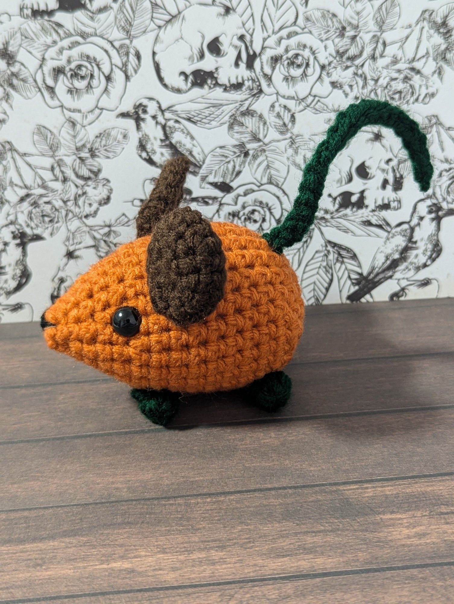 A pumpkin themed crocheted mouse