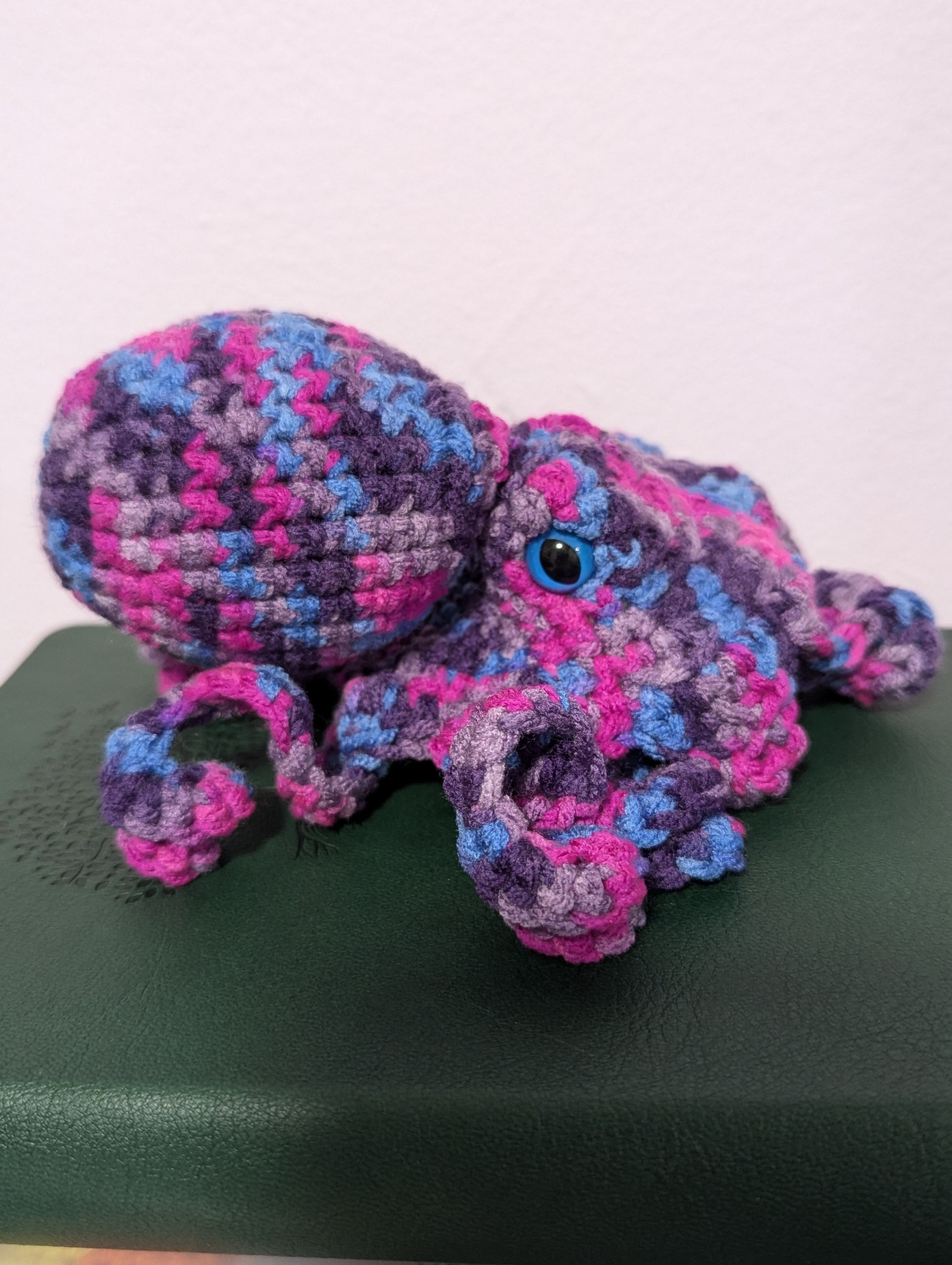 A pink and purple variegated crocheted octopus