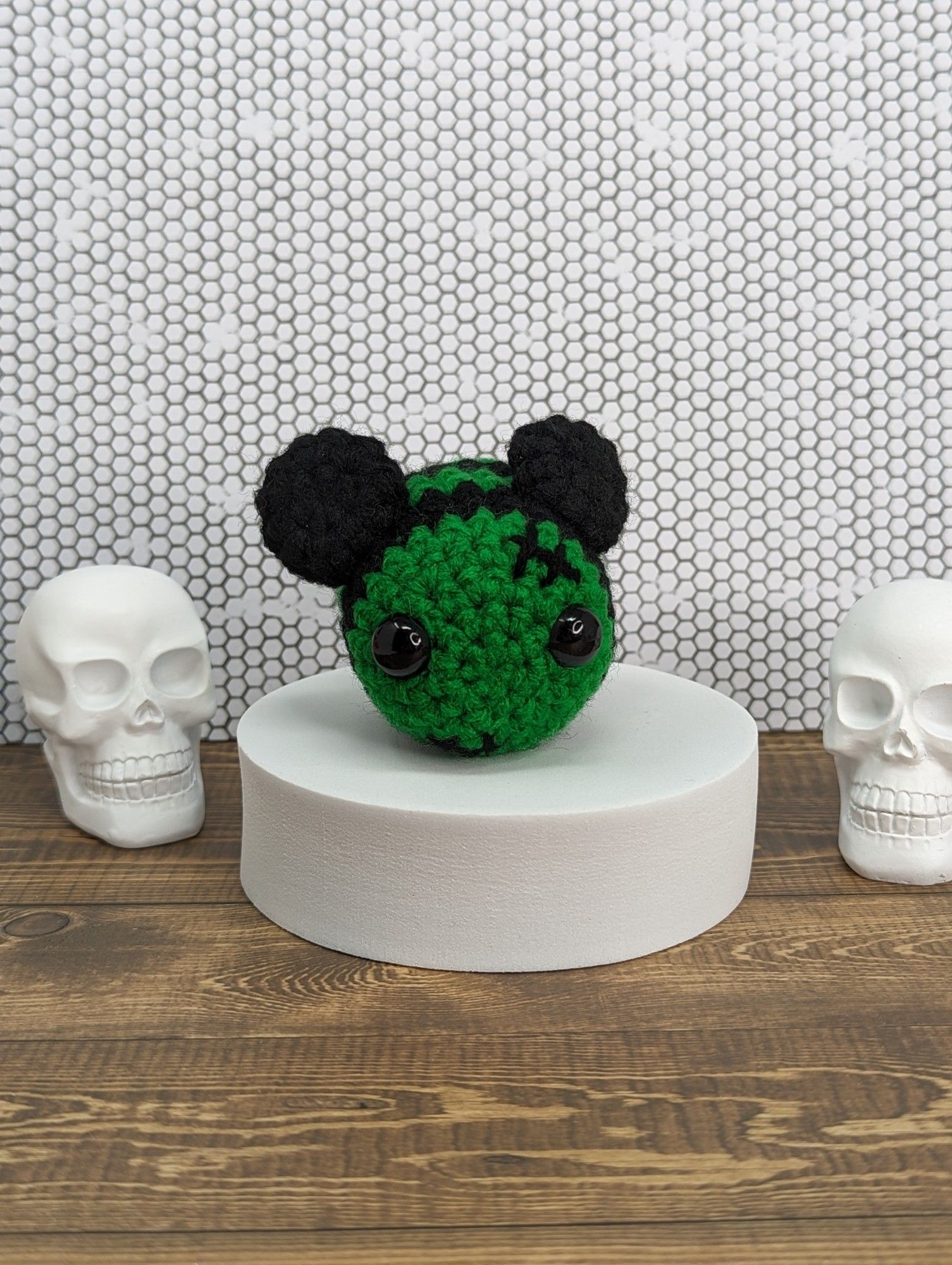 A crocheted bee dressed up like Frankenstein's monster