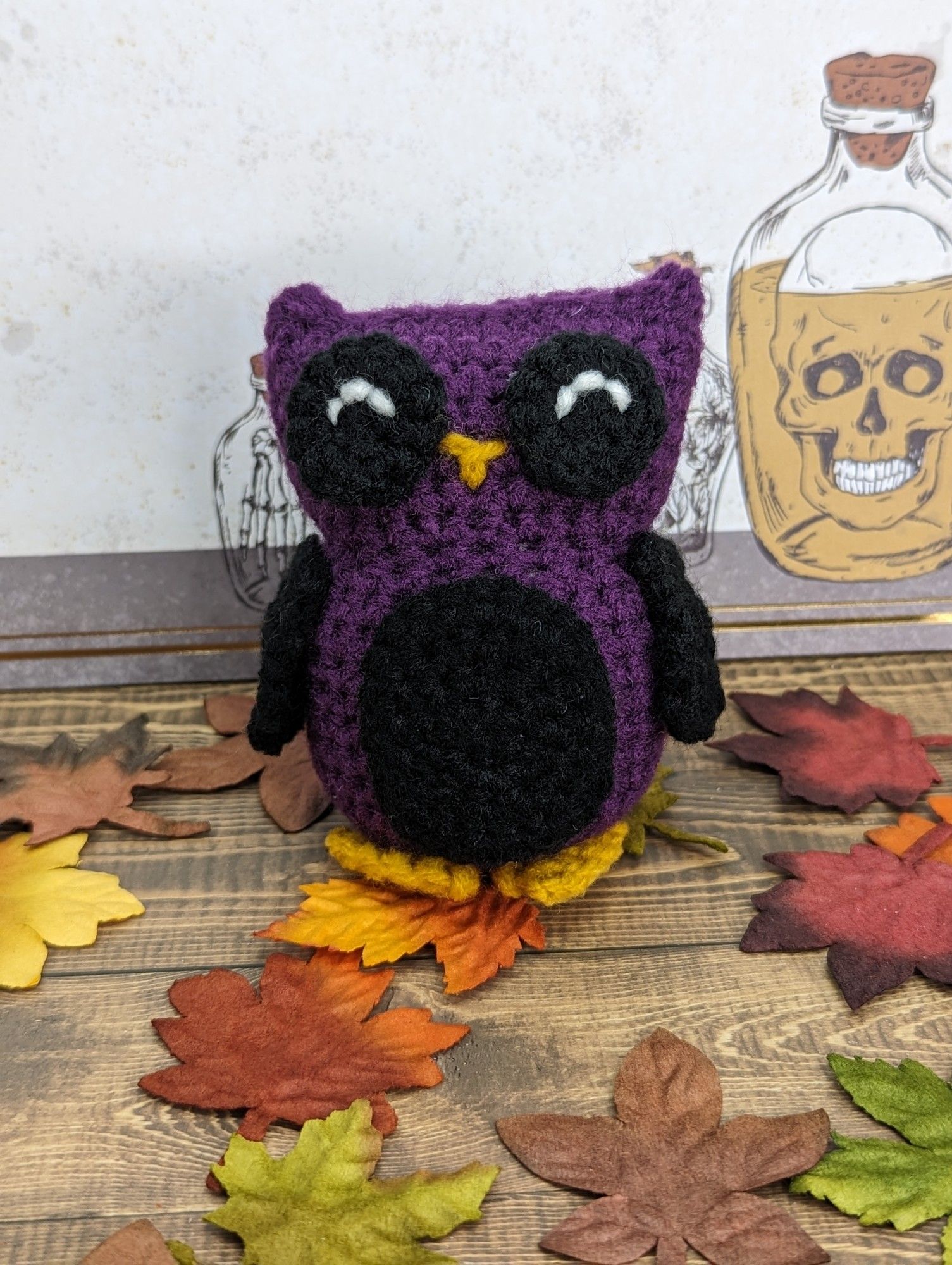 A purple and black crocheted owl