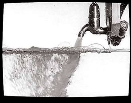 A TV screen showing a tap gushing water in such a way that it appears to be filling up the TV set