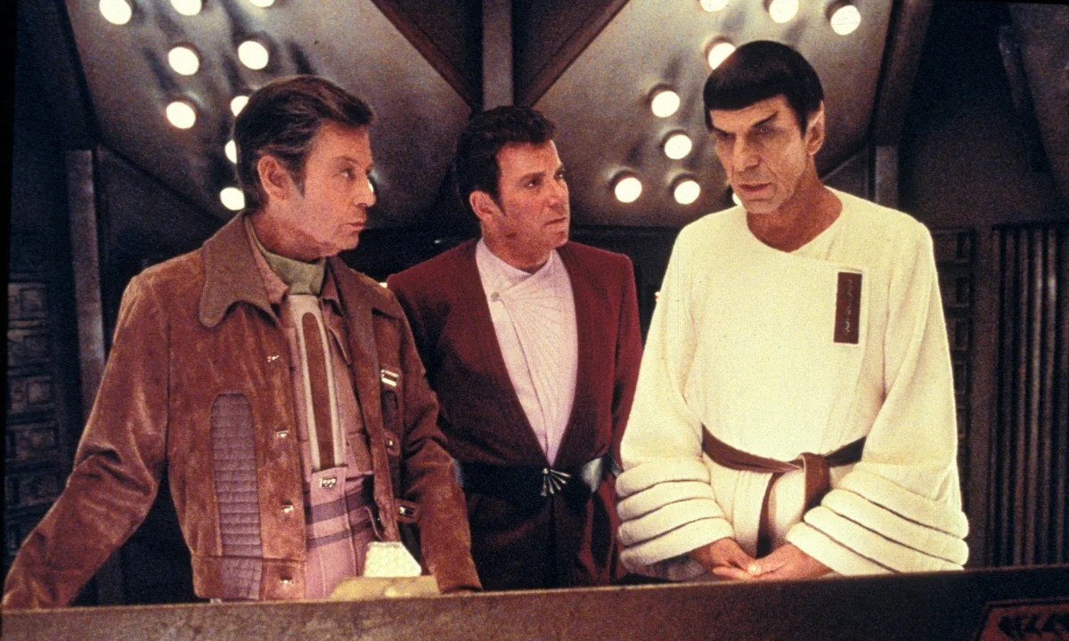 McCoy in and amazing pseudo business casual jumpsuit and brown leather jacket combo, Kirk dressed like warmed over shit, and Spock in what looks like a stolen terrycloth hotel bathrobe