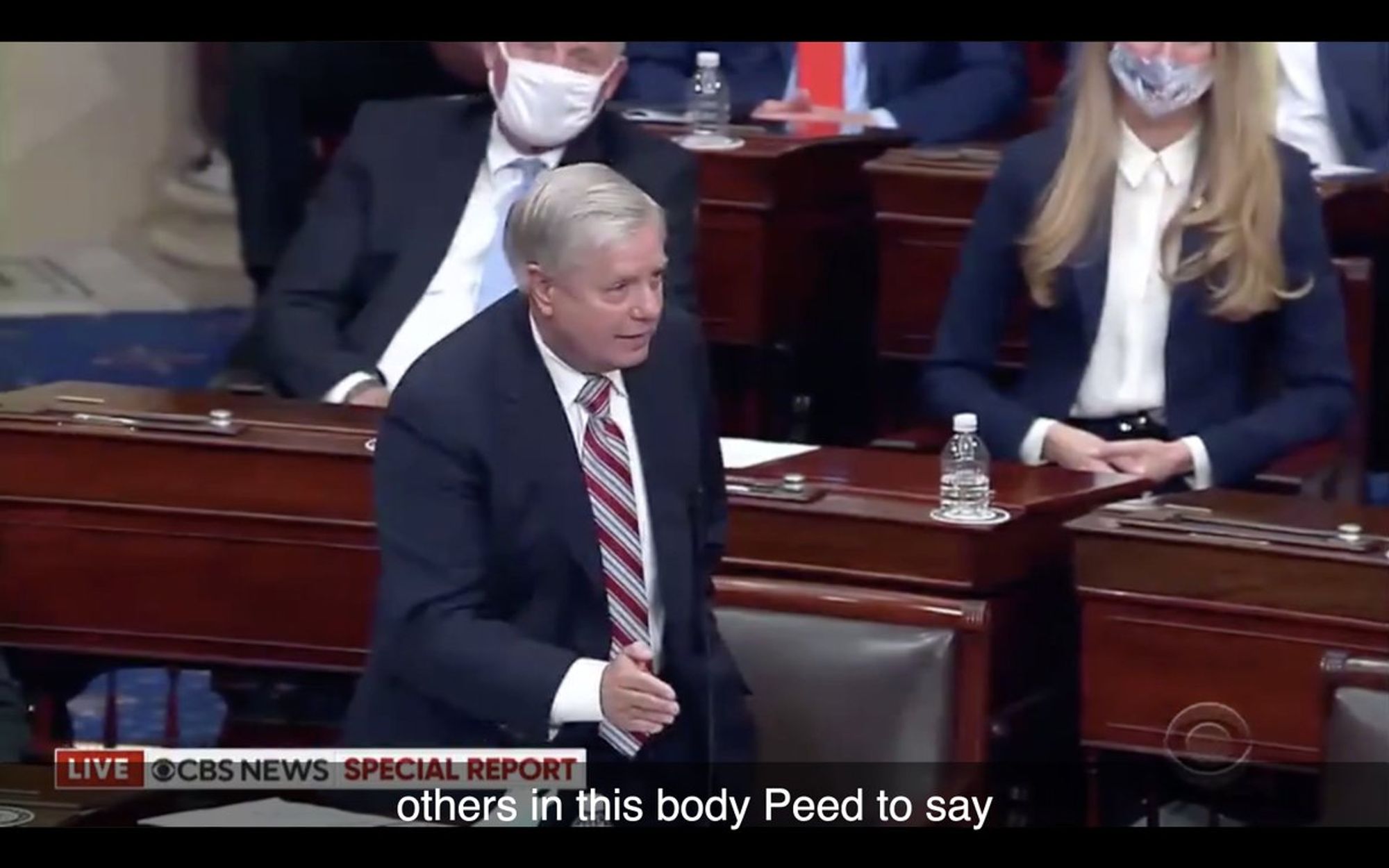 South Carolina Republican Senator Lindsey Graham stands in front of Congress in a live special report from CBS News that is auto-captioned "others in this body Peed to say." Date unknown.