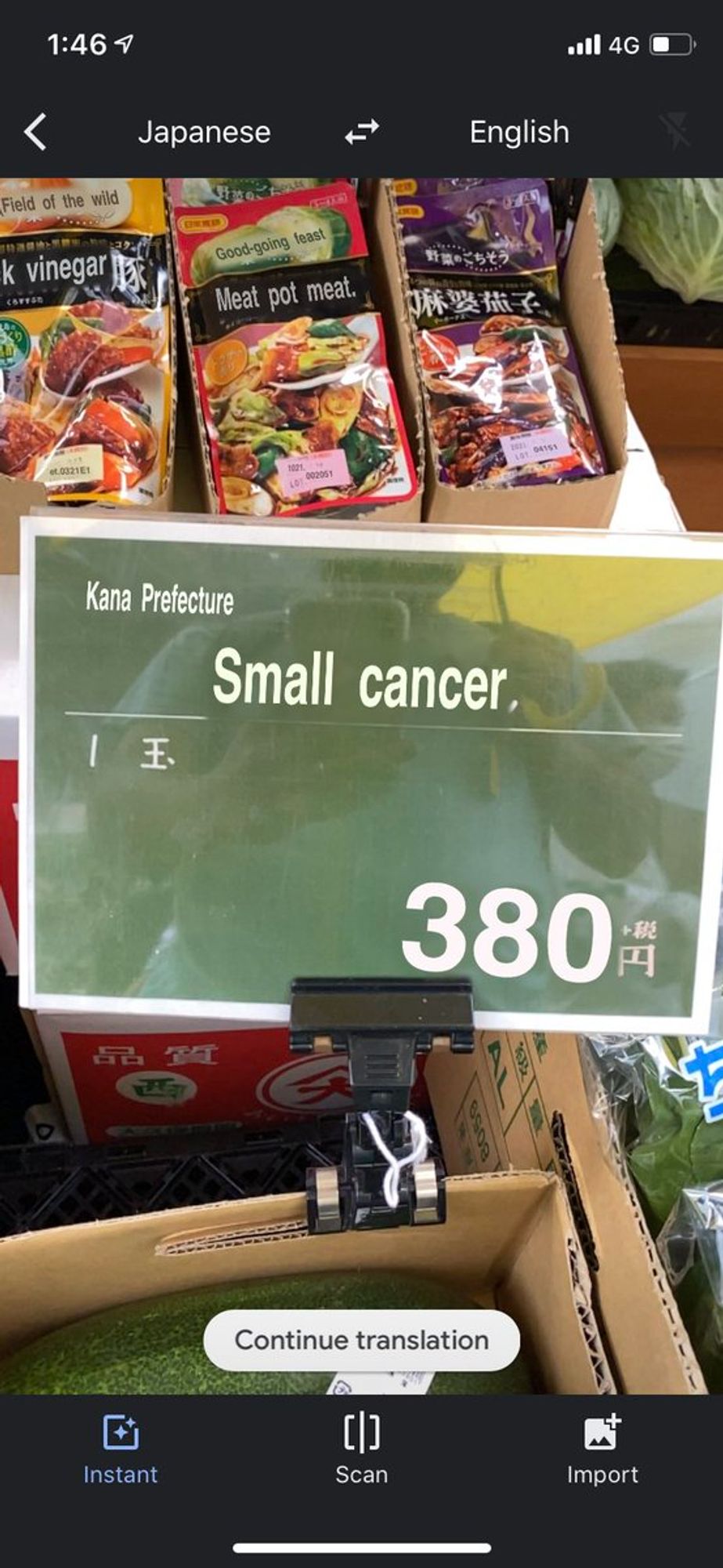 A sign for fresh produce with a Google Translate mistranslation reading "Kana Prefecture Small cancer 380円."