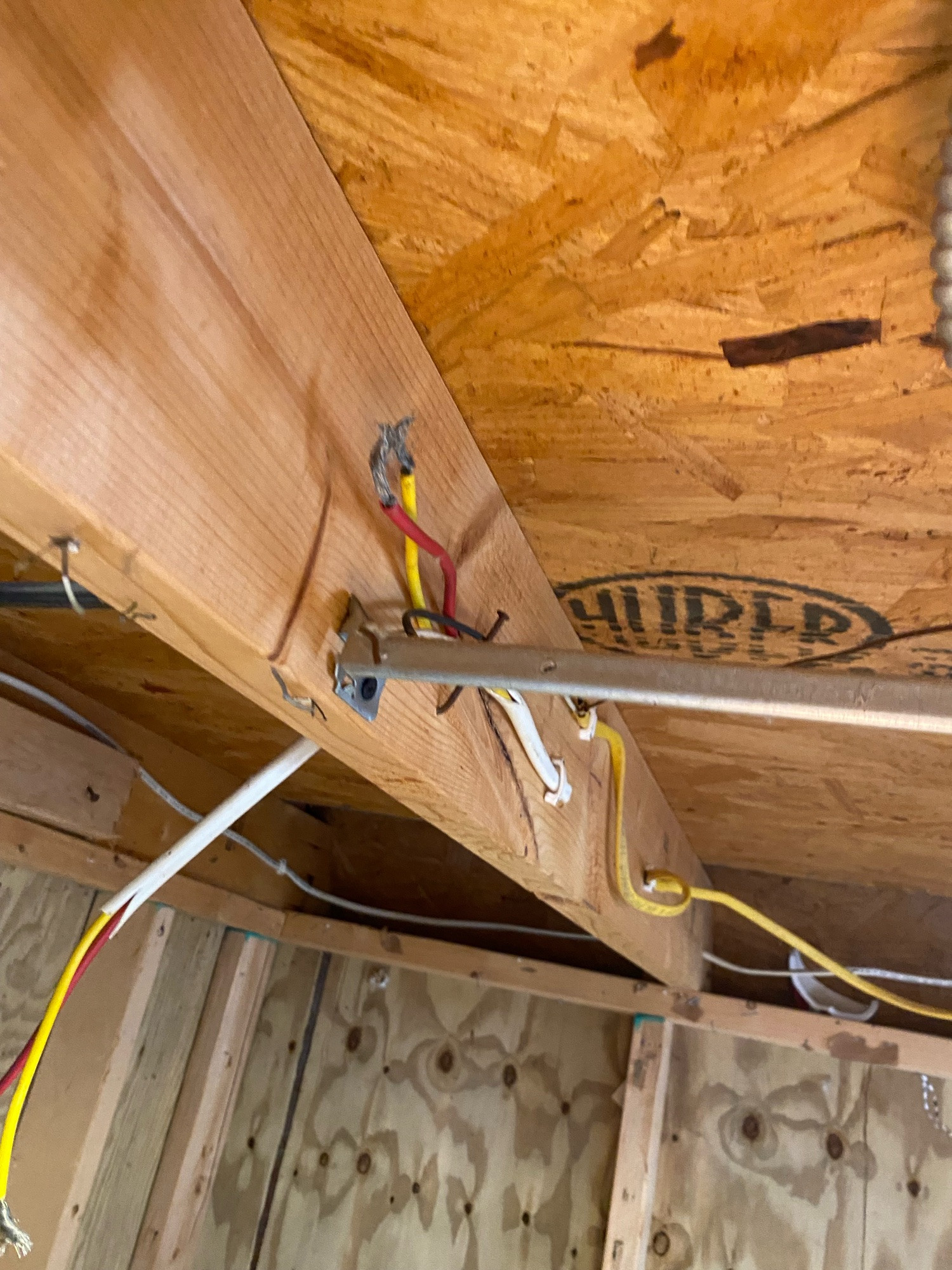 Where the cable comes out on the other side of the loft floor joist.