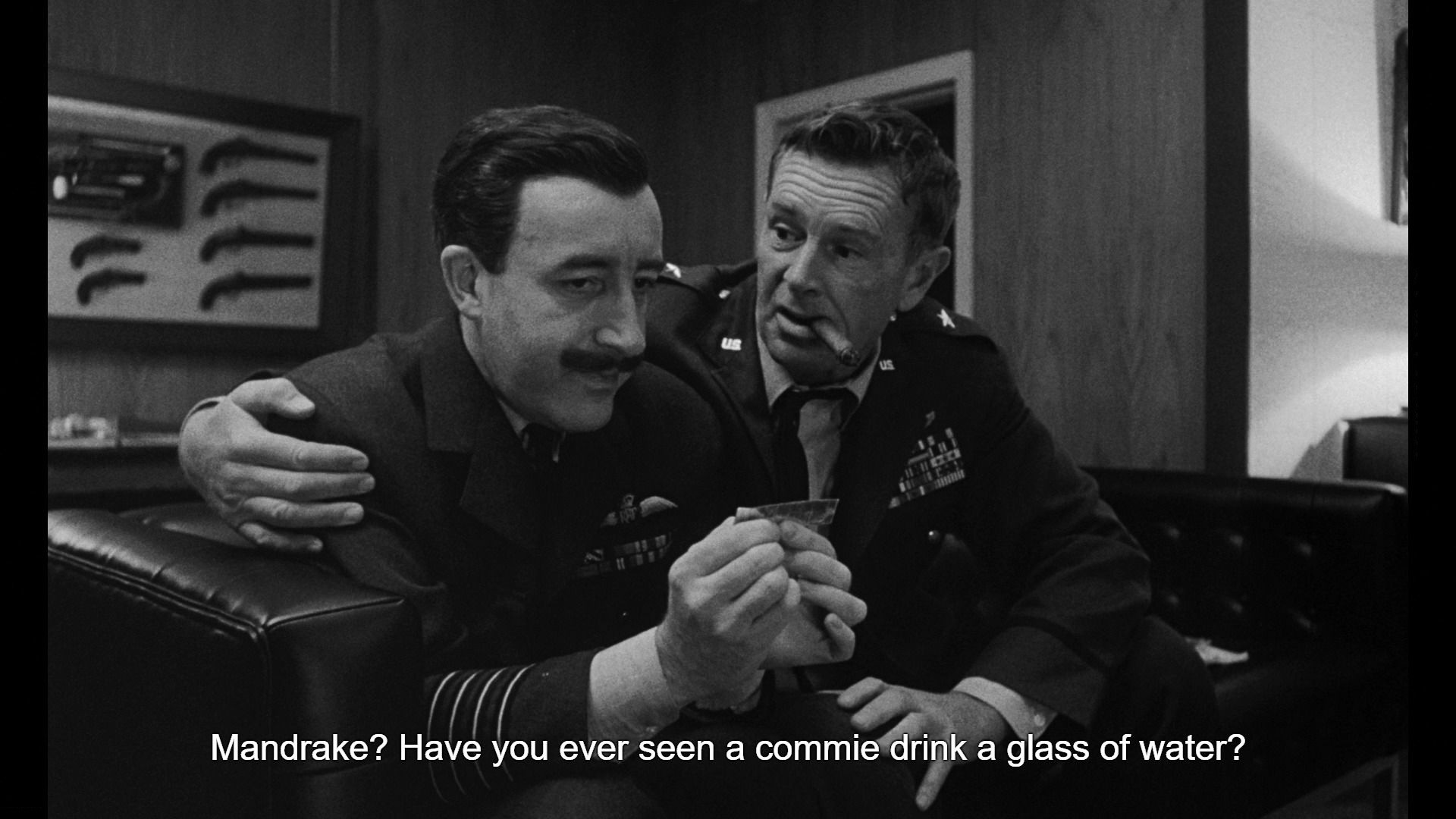 screenshot from dr strangelove of the crazed general asking mandrake if he has "ever seen a commie drink a glass of water?"