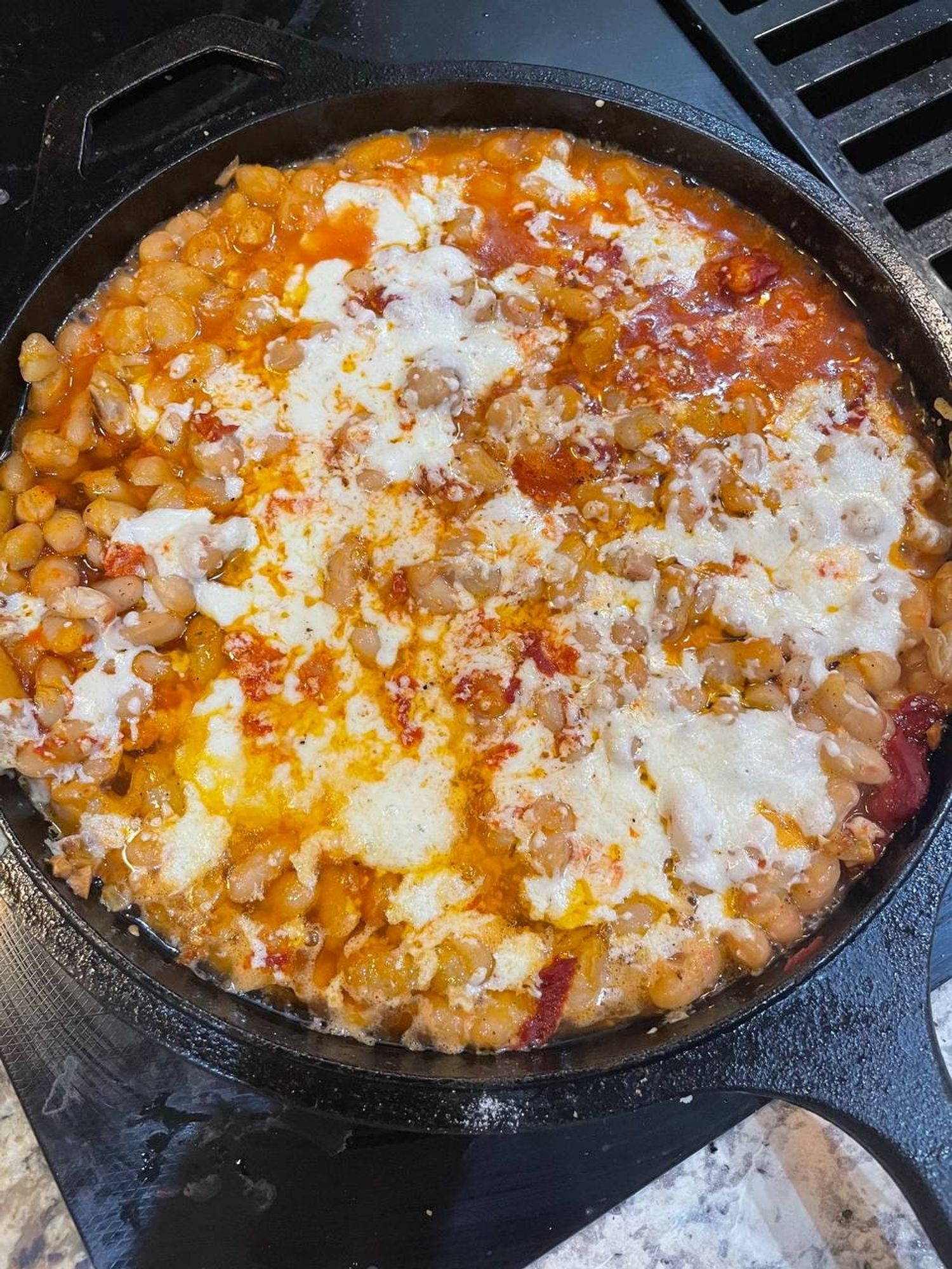 top down view of the meal, after i almost burnt my hand by grabbing the handle after it came out of the 475 degree oven. https://web.archive.org/web/20240530060452/https://cooking.nytimes.com/recipes/1019681-cheesy-white-bean-tomato-bake