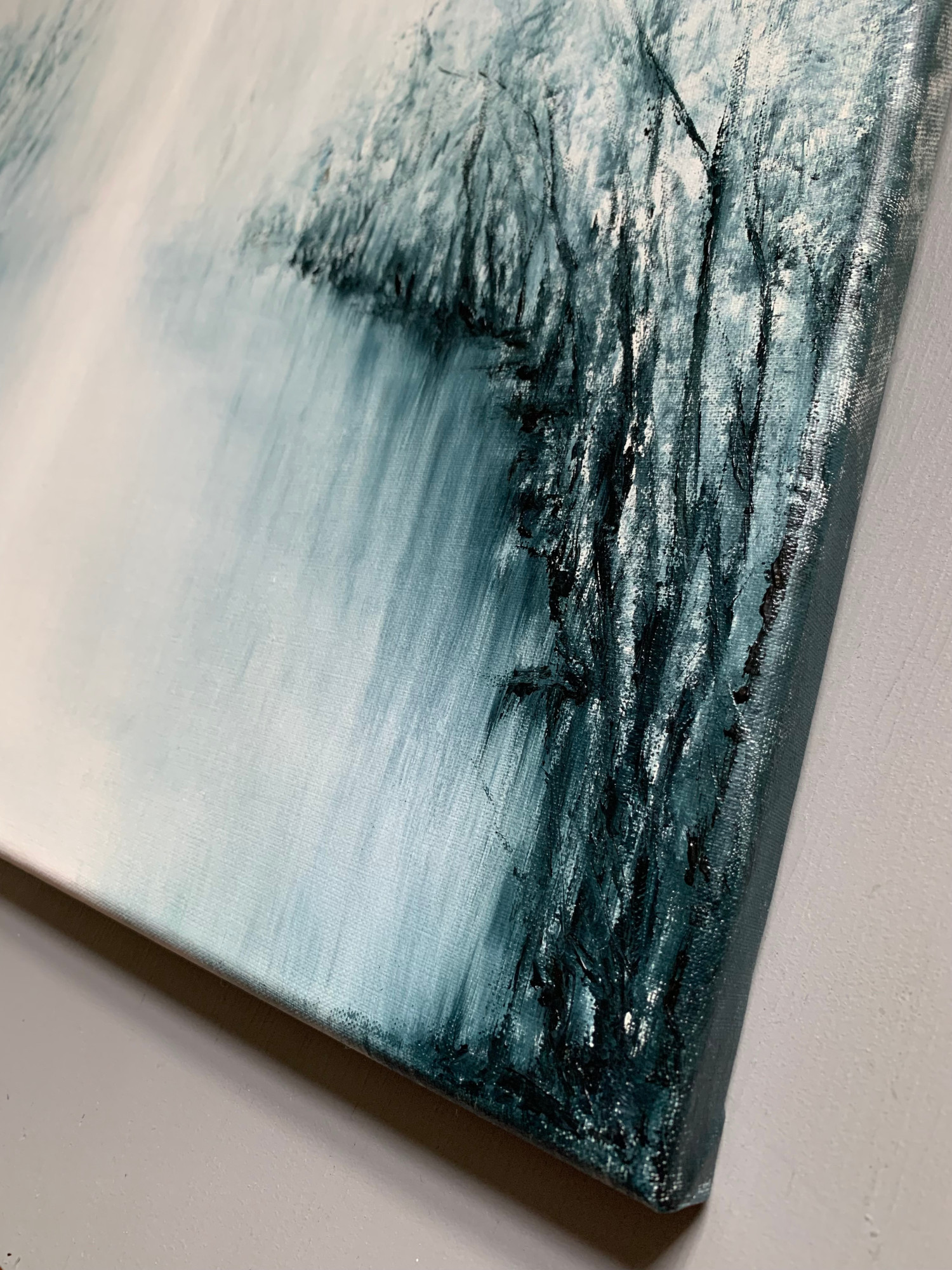 Original oil painting by Tisha Mark, "The Space Between" 16"x20" oil on linen (2023), detail at an angle from right. Abstract foggy landscape painting, painted in a limited palette of blues and whites.