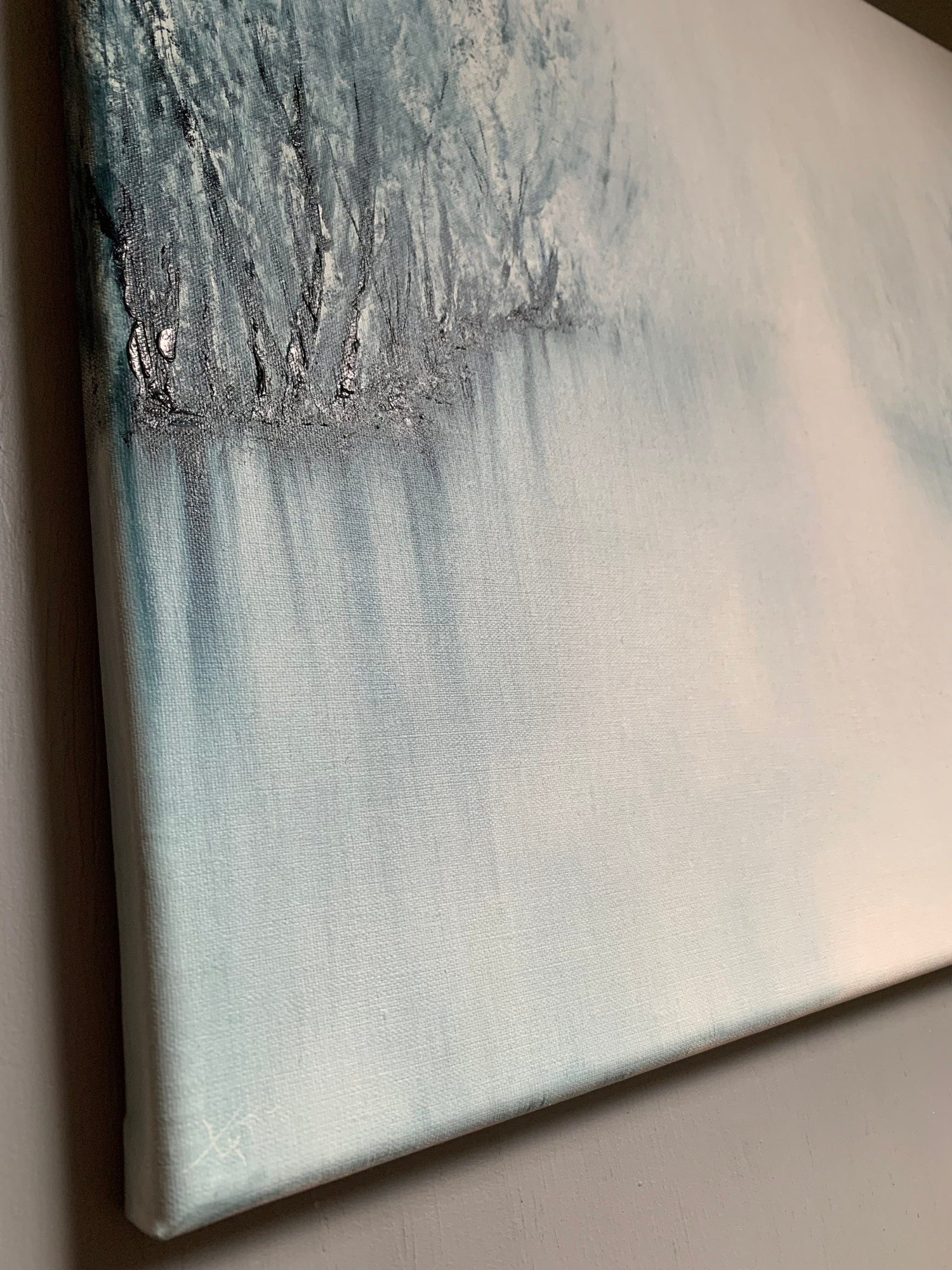 Original oil painting by Tisha Mark, "The Space Between" 16"x20" oil on linen (2023), detail at an angle from left to show textures. Abstract foggy landscape painting, painted in a limited palette of blues and whites.