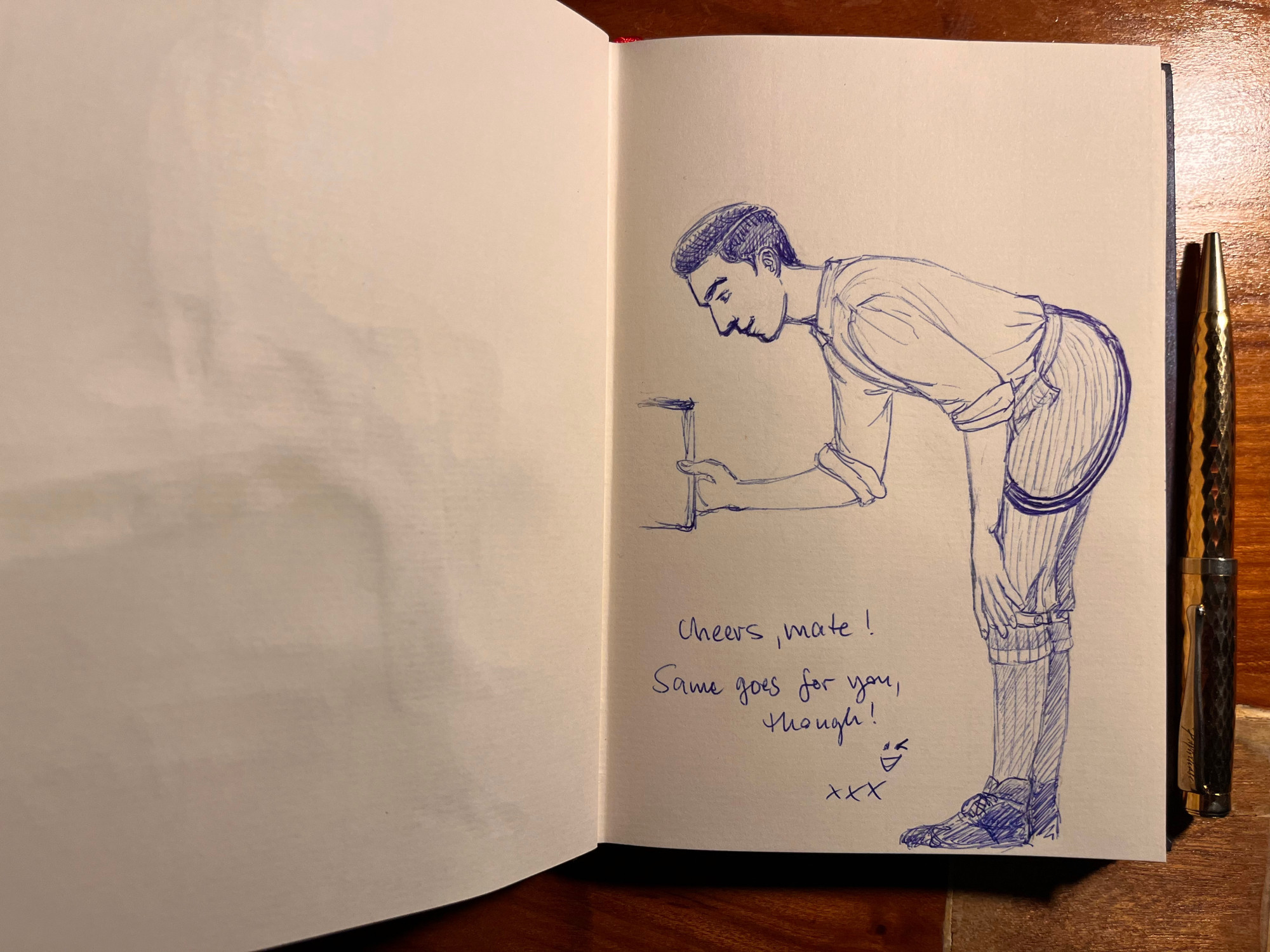 Another double page spread from the same notebook. On the right hand page, Charles has sketched Edwin with a blue biro while he bends over to retrieve a book from a shelf. He has stripped down to shirt (with the sleeves rolled up) and his knickerbockers, with his braces dangling at his side. Next to the drawing, Charles has written: Cheers, mate! Same goes for you, though! followed by a winking smiley and three x.