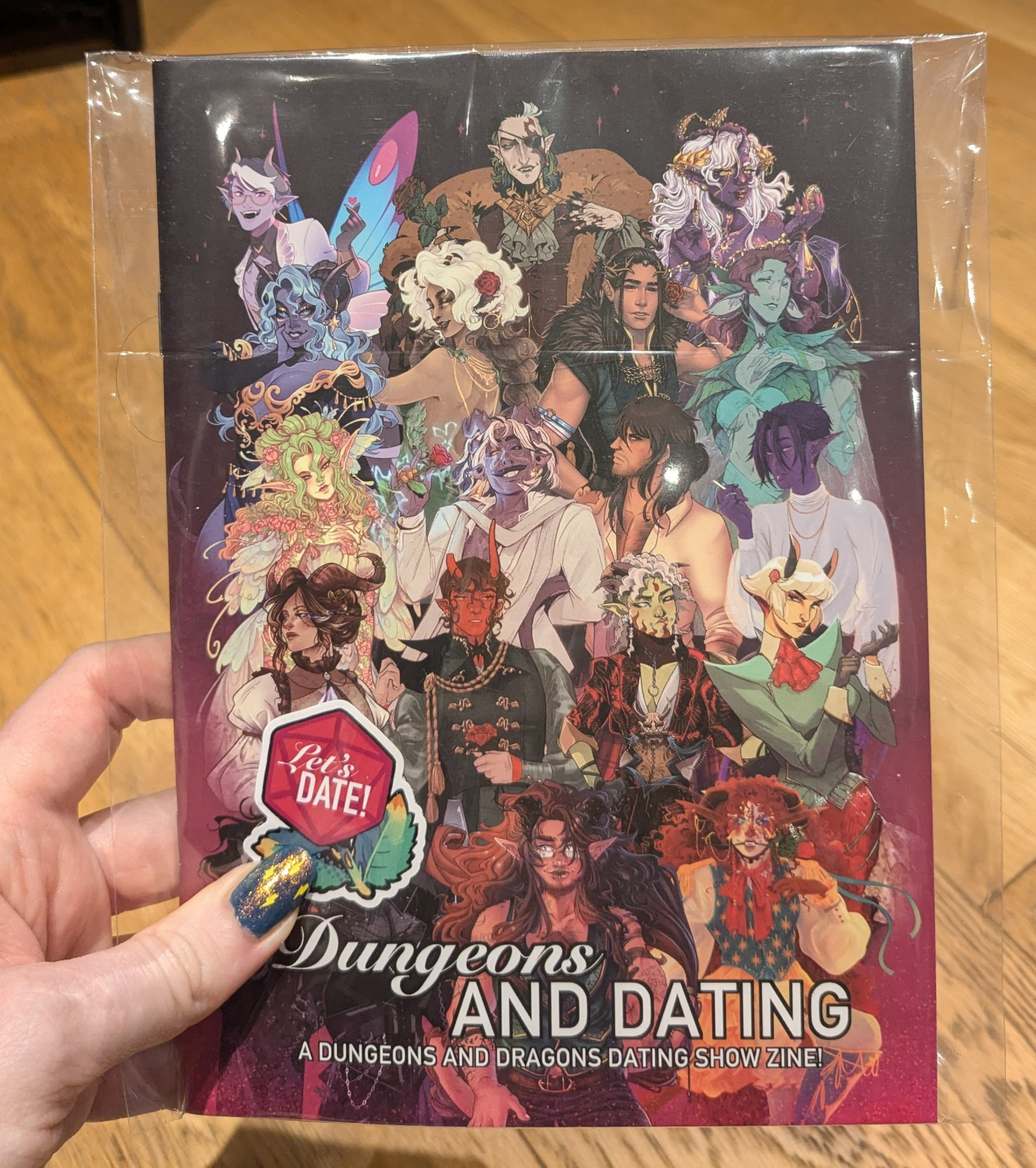 The front cover of Dragons and Dating - a Dungeons and Dragons Dating Show Zine. Featuring a rose polyhedral sticker with the text 'let's date!'. The cover has an array of detailed original fantasy characters. Artists include: Ghost Dandy Mi, Bex Read, lilbluubird, Dottea, Eren Angiolini, Sarah Mason, Bara_Izu, KannterArt, Kroov, Sophiralou, TopBanana_Jam, Bailie Rosenlund, lilhappycloud, enjoliblue, Sabattons, HollyDoodles, Zombie_Octopus and Veldenmire. Formatting/design and sticker artwork by Kroov.