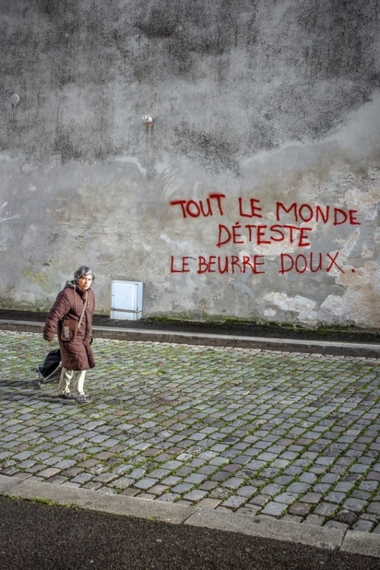 Tag sur un mur en Bretagne devant lequel passe une dame avec son chariot de course : « EN BRETAGNE, TOUT LE MONDE DÉTESTE LE BEURRE DOUX. » ✊
© Bruno Ansker, Douarnenez.