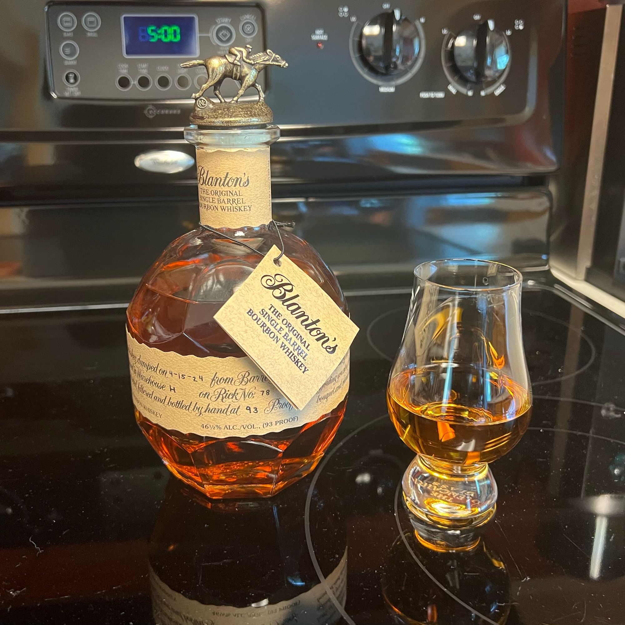 Bottle of Blanton's bourbon with a clock showing 5:00 p.m.