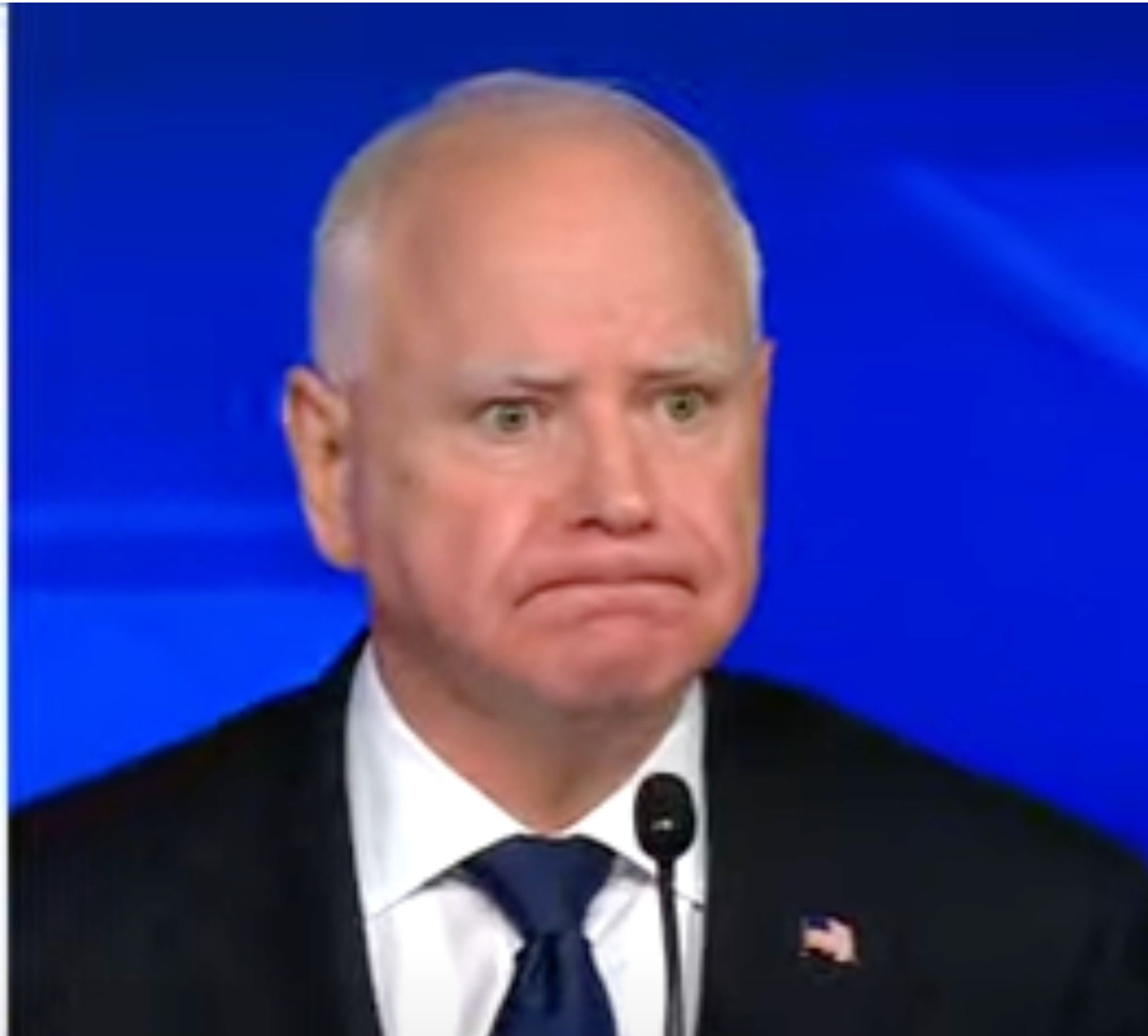 Screenshot of Minnesota Governor Tim Walz during the VP debate, wearing a Minnesota Grimace that could cut steel